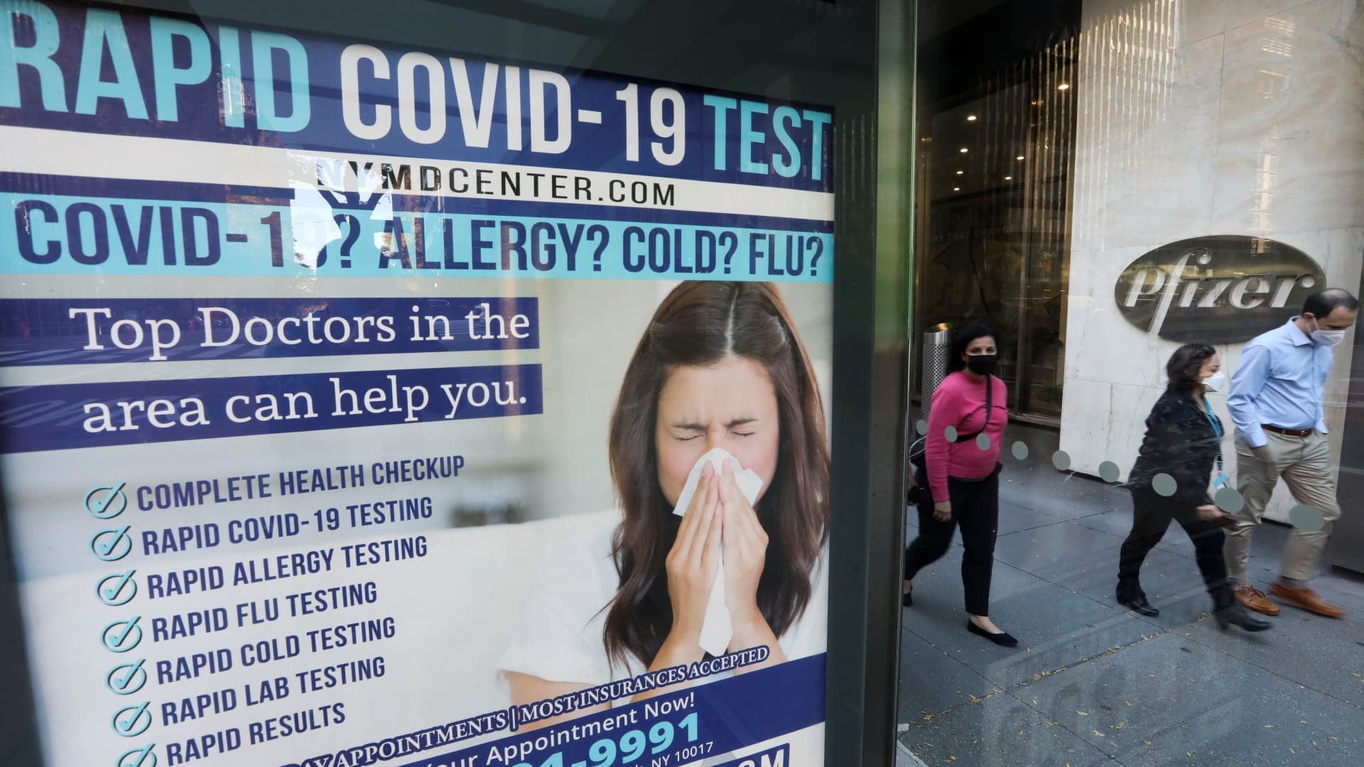 Pedestrians walk past an advertisement of COVID-19 test in New York, the United States, Nov. 9, 2020.