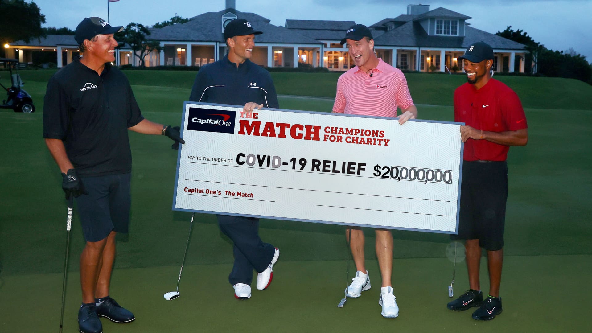 Tiger Woods and former NFL player Peyton Manning celebrate defeating Phil Mickelson and NFL player Tom Brady of the Tampa Bay Buccaneers on the 18th green during The Match: Champions For Charity at Medalist Golf Club on May 24, 2020 in Hobe Sound, Florida.