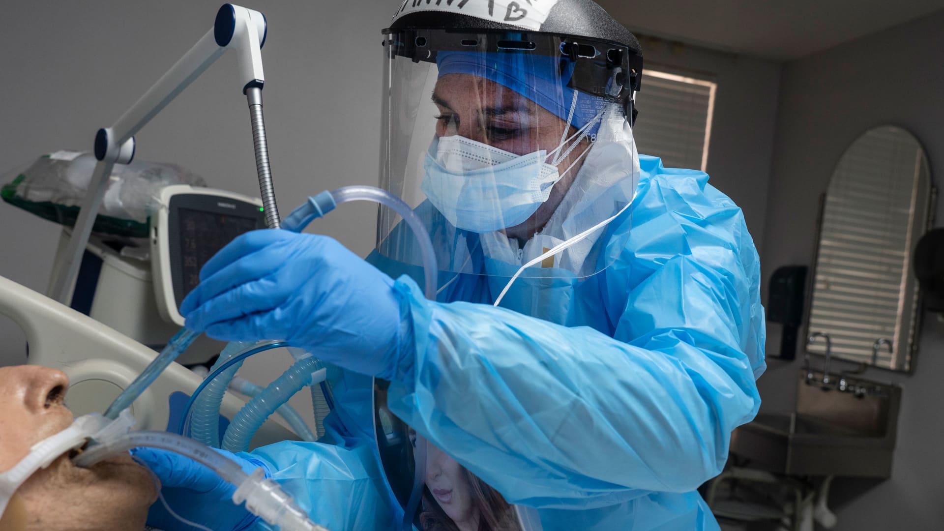 A medical staff member treats a patient suffering from coronavirus in the COVID-19 intensive care unit (ICU) at the United Memorial Medical Center (UMMC) on November 10, 2020 in Houston, Texas.