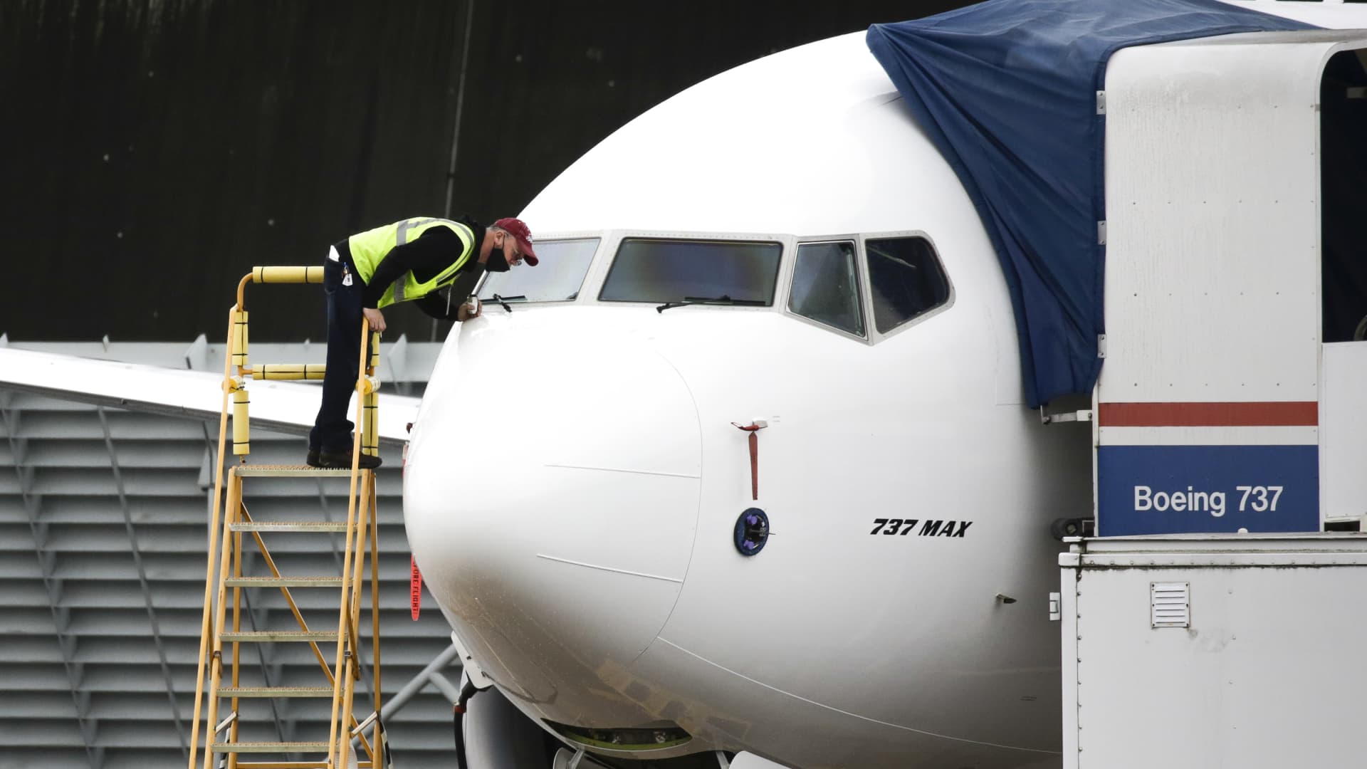 A worker inspects a Boeing 737 MAX airliner at Renton Airport adjacent to the Boeing Renton Factory in Renton, Washington on November 10, 2020.