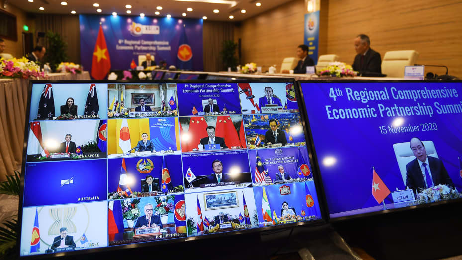 Vietnam's Prime Minister Nguyen Xuan Phuc is pictured on the screen (R) as he addresses his counterparts during the 4th Regional Comprehensive Economic Partnership (RCEP) Summit held online on Nov. 15, 2020.