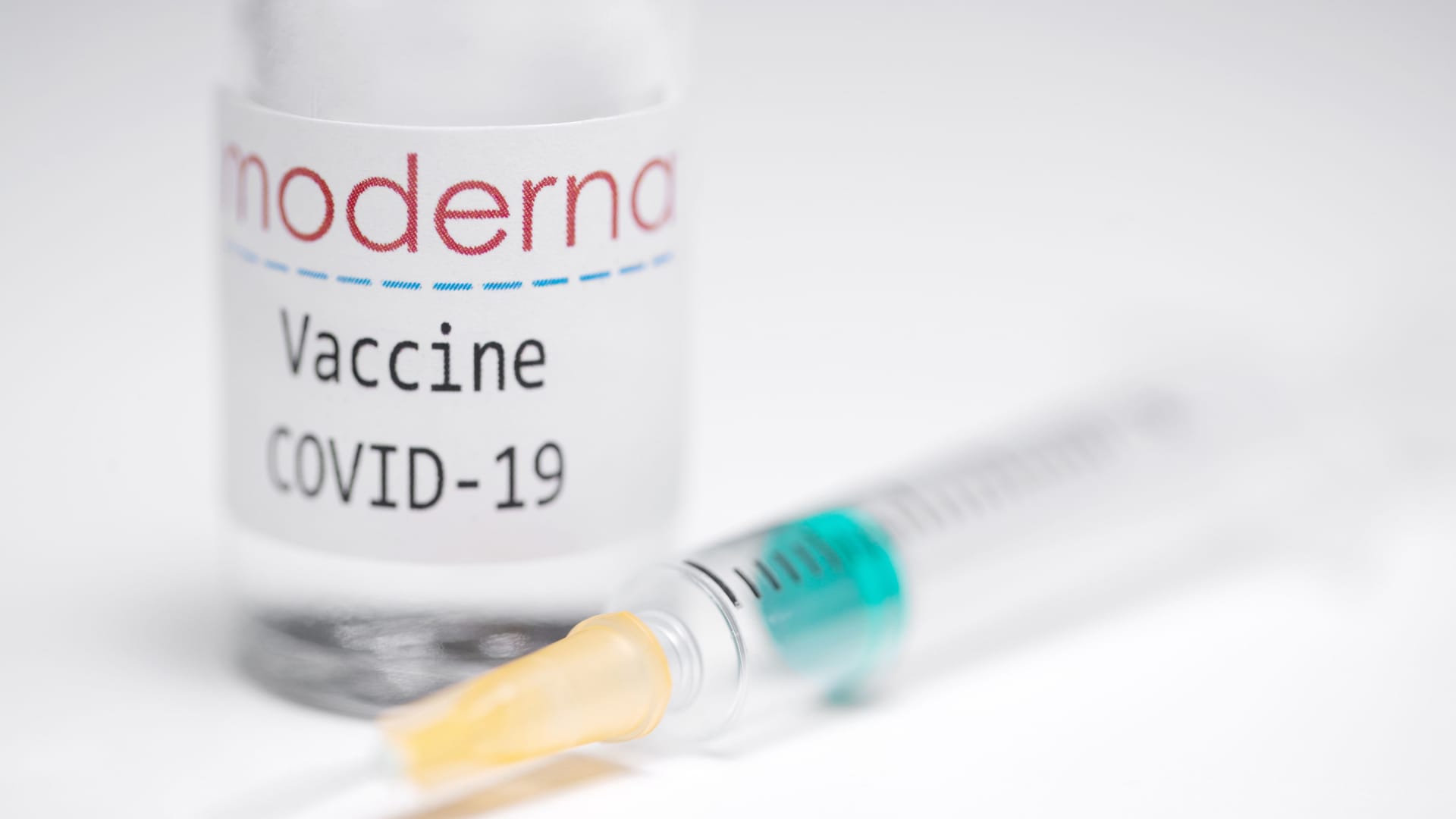 This creative image taken in a studio in Paris on November 16, 2020, showing a syringe and a vaccine vial with the reproducted logo of a US biotech firm Moderna, illustrates the announcement of an experimental vaccine against Covid-19 from Moderna that would be nearly 95% effective, marking a second major step forward in the quest to end the Covid-19 pandemic.