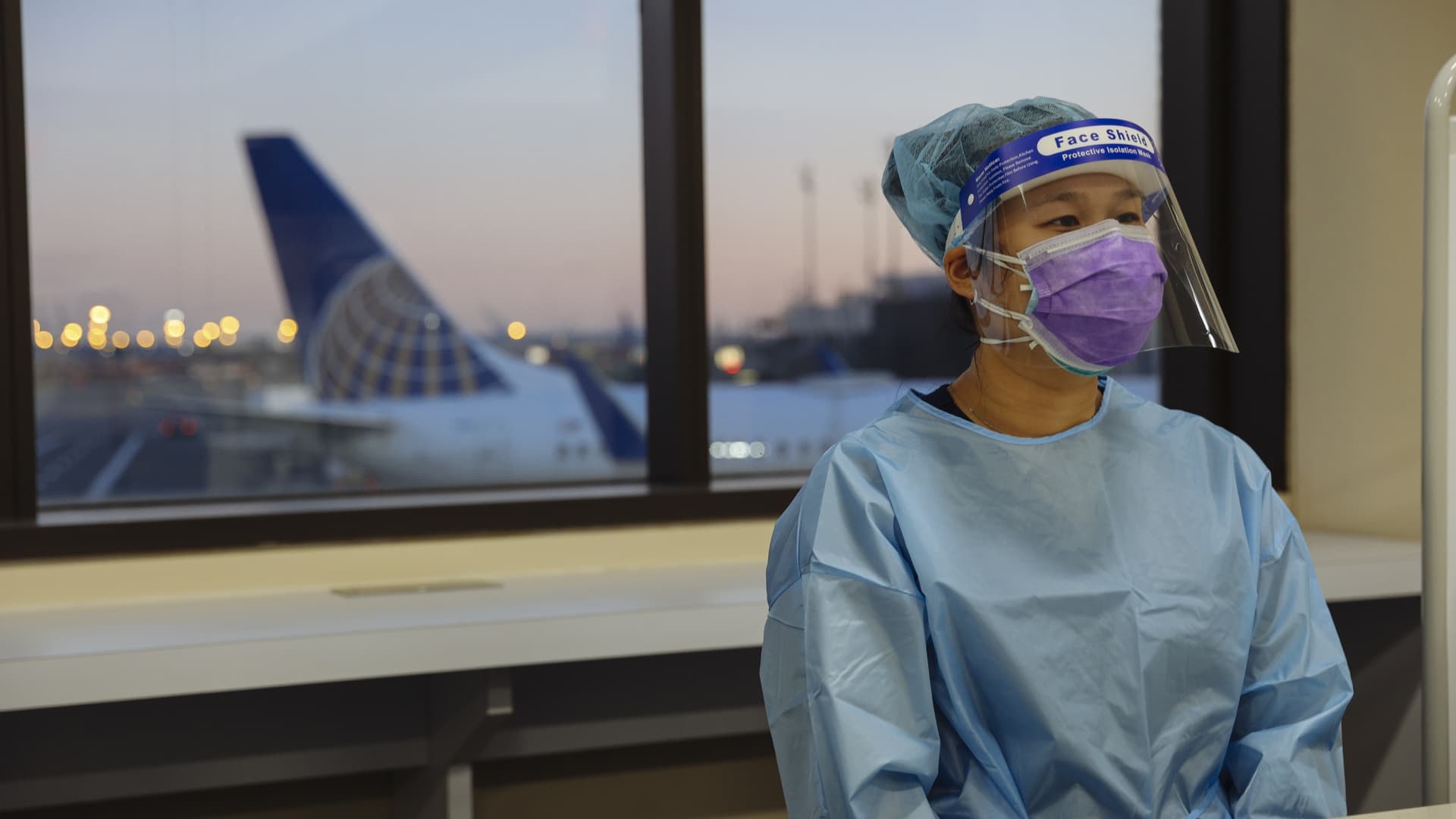 A healthcare worker wears personal protective equipment (PPE) during a United Airlines Covid-19 test pilot program at Newark Liberty International Airport in Newark, New Jersey, U.S., on Monday, Nov. 16, 2020.