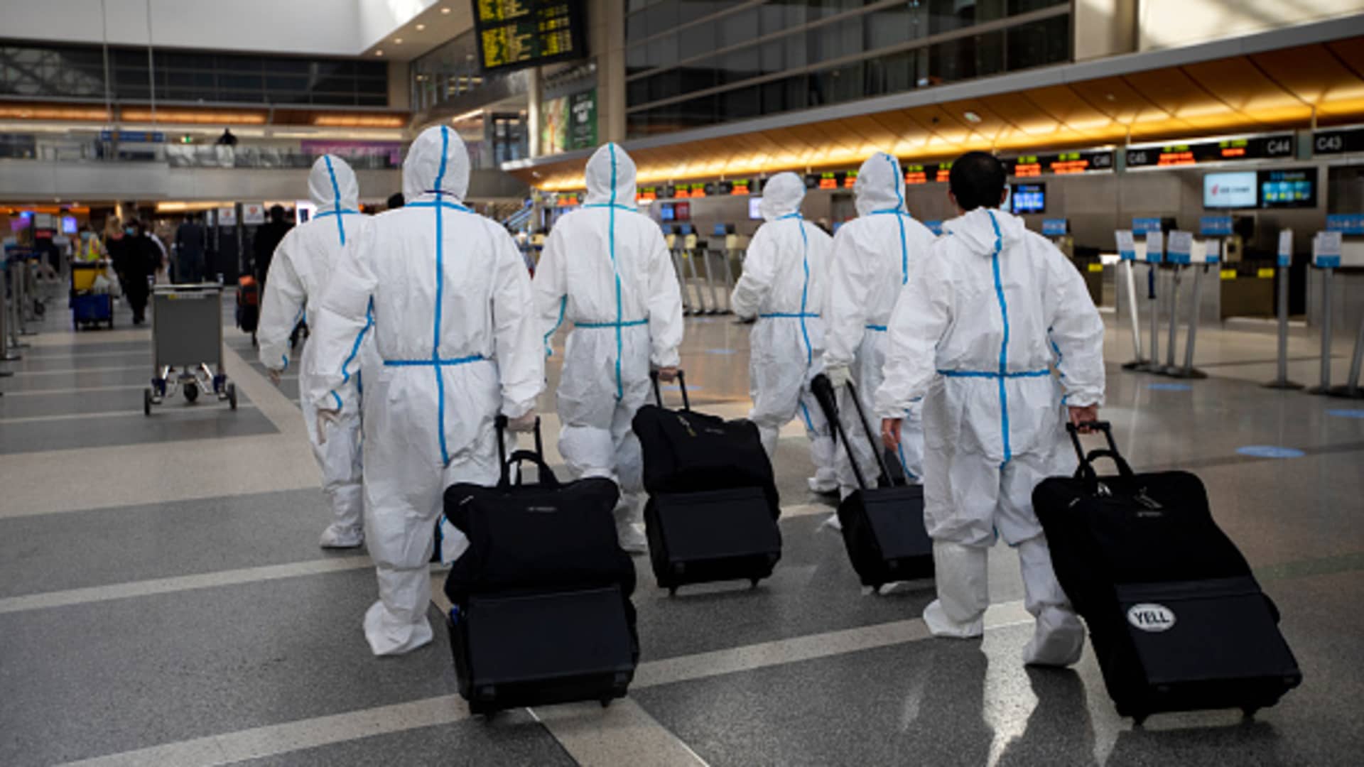 During the global coronavirus pandemica group of people wearing personal protective equipment walk in Tom Bradley international at LAX on Tuesday, Nov. 17, 2020 in Los Angeles, CA.