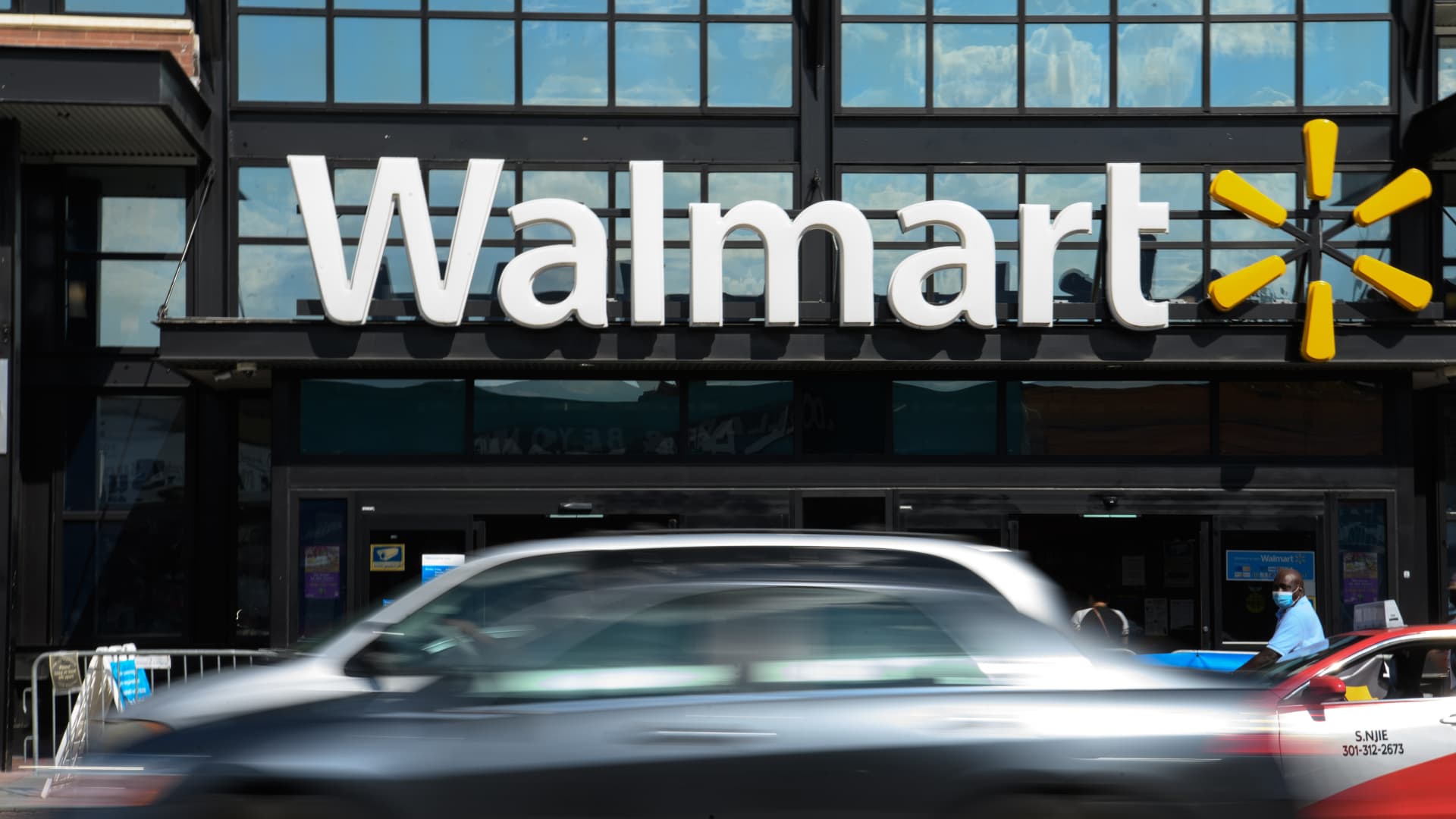 Cars drive past a Walmart store in Washington, DC, on August 18, 2020.