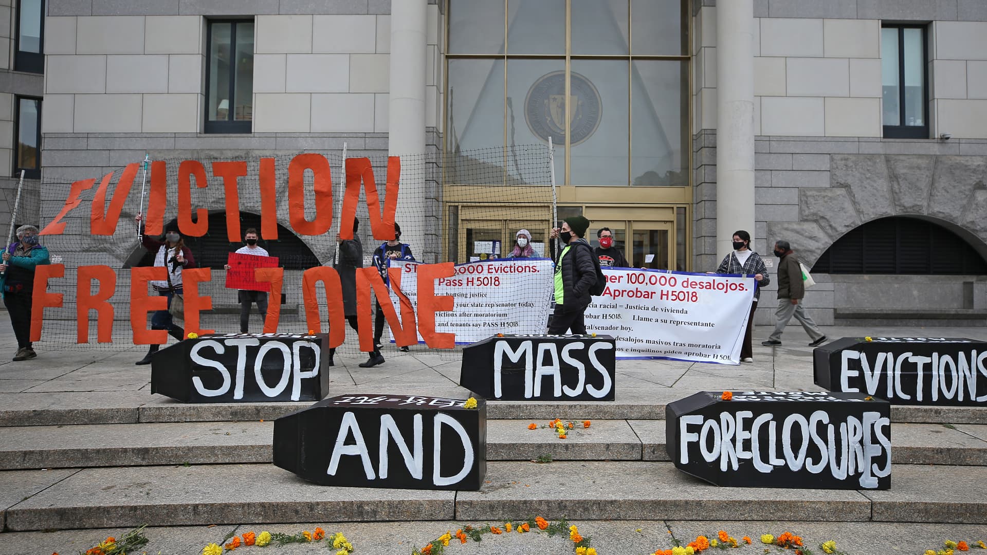 Demonstrators display signs calling for an end to evictions and foreclosures during a rally at Boston Housing Court outside the Edward W. Brooke Courthouse on Oct. 29, 2020.