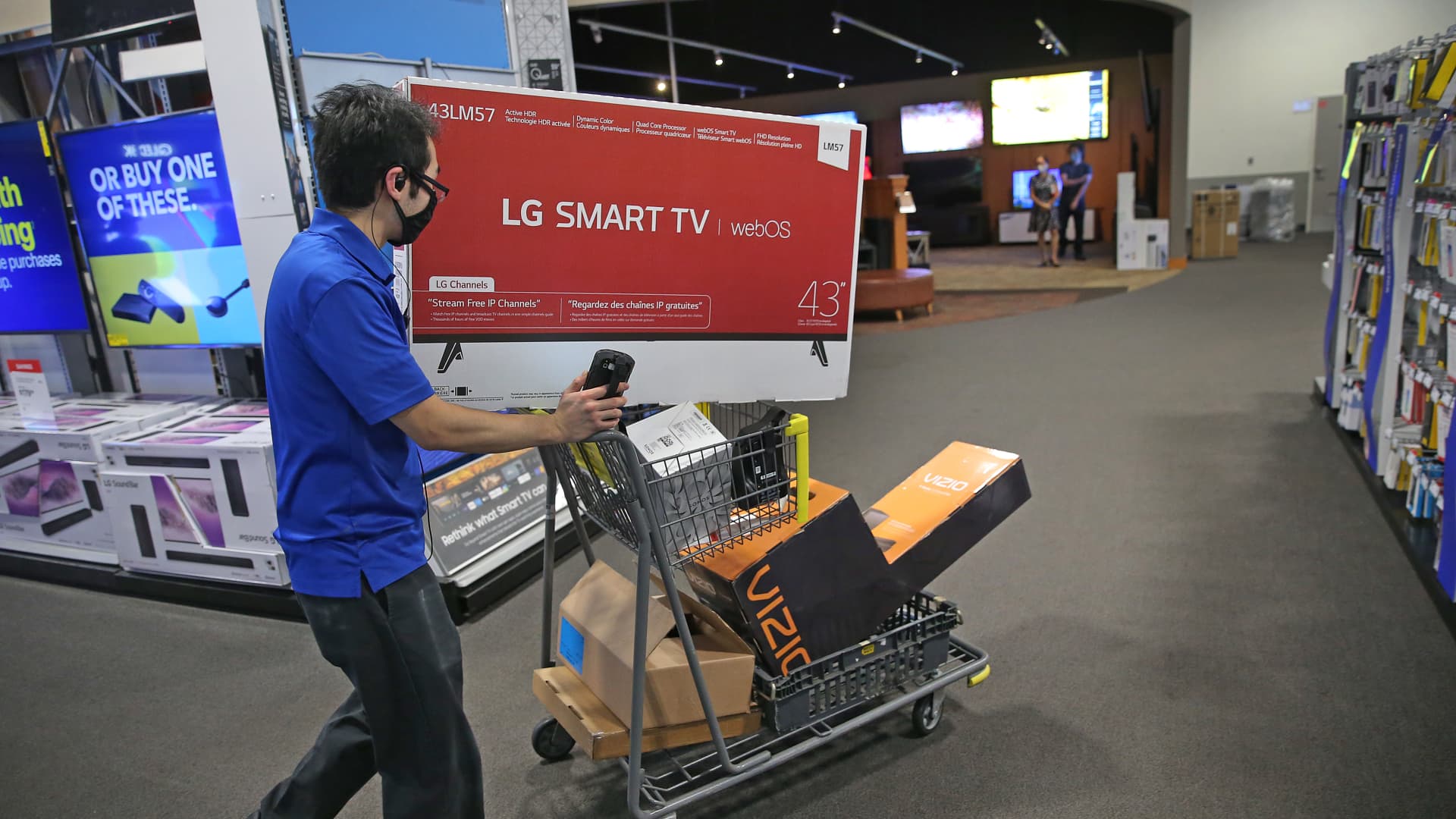 A Best Buy employee uses a cart to do shopping for an online customer at South Bay Center in Boston on Nov. 10, 2020. Retail trends are changing during the Covid-19 pandemic, and Best Buy has begun offering their holiday Black Friday sales and deals earlier in the month to thin out crowds.