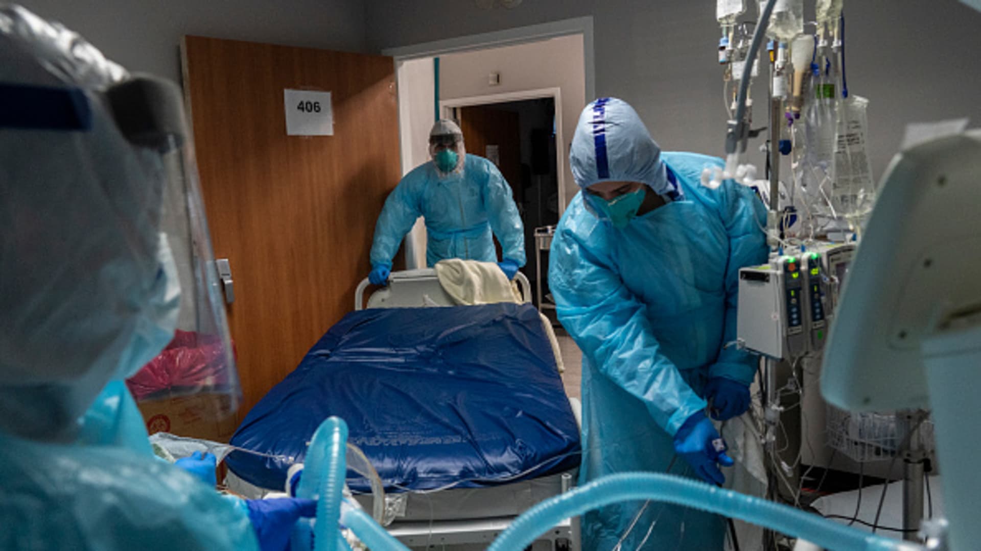 Medical staff members sort lines and pipes connected to a patient in the COVID-19 intensive care unit (ICU) at the United Memorial Medical Center on November 19, 2020 in Houston, Texas.