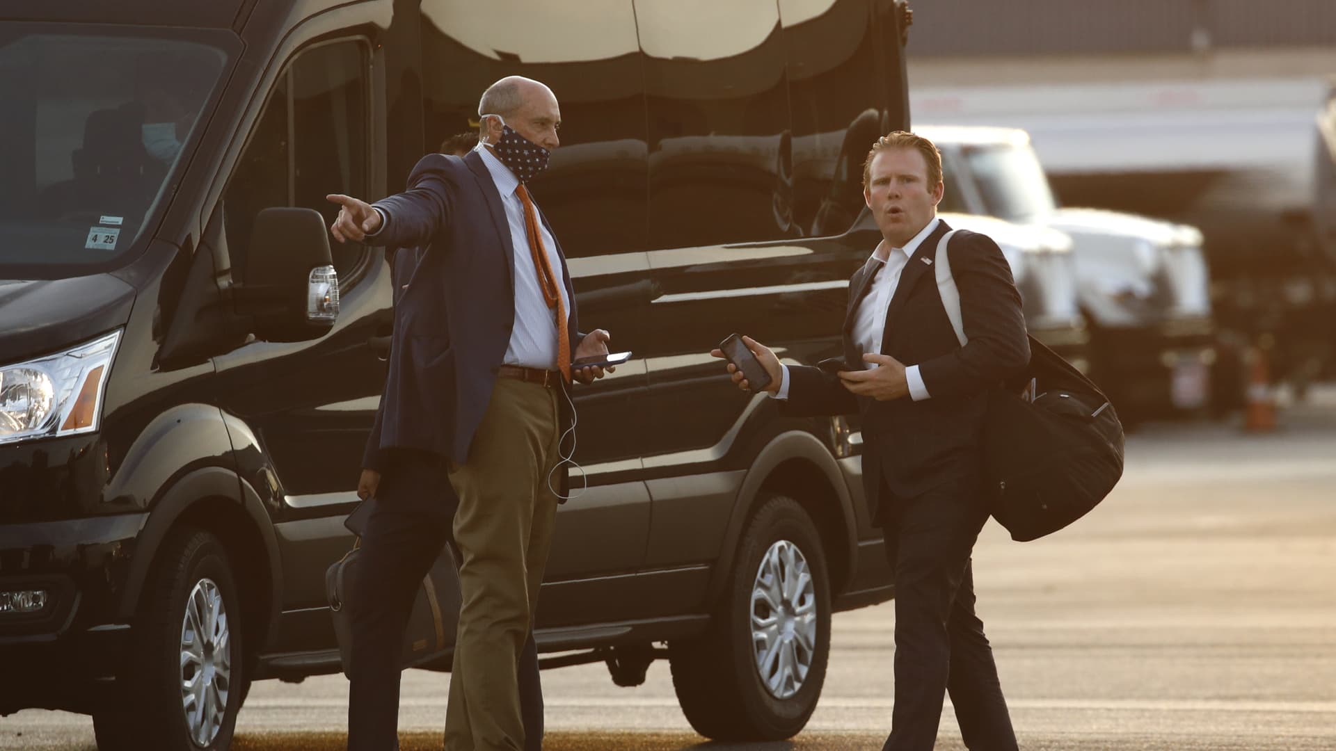 Andrew Giuliani, Special Assistant to President Donald Trump, right, walks to a van after stepping off Air Force One at Morristown Municipal Airport in Morristown, N.J., Friday, July 24, 2020.