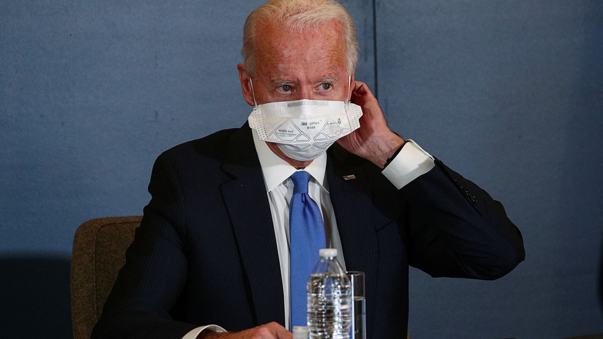 U.S. President-elect Joe Biden removes his face mask as he meets with Speaker of the House Nancy Pelosi (D-CA) and Senate Minority Leader Chuck Schumer (D-NY) at his transition headquarters in the Queen theater in Wilmington, Delaware, U.S., November 20, 2020.