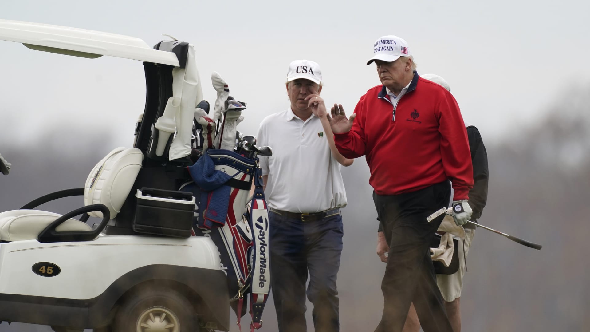 President Donald Trump waves as he plays golf at Trump National Golf Club in Sterling, Va., Saturday, Nov. 21, 2020.