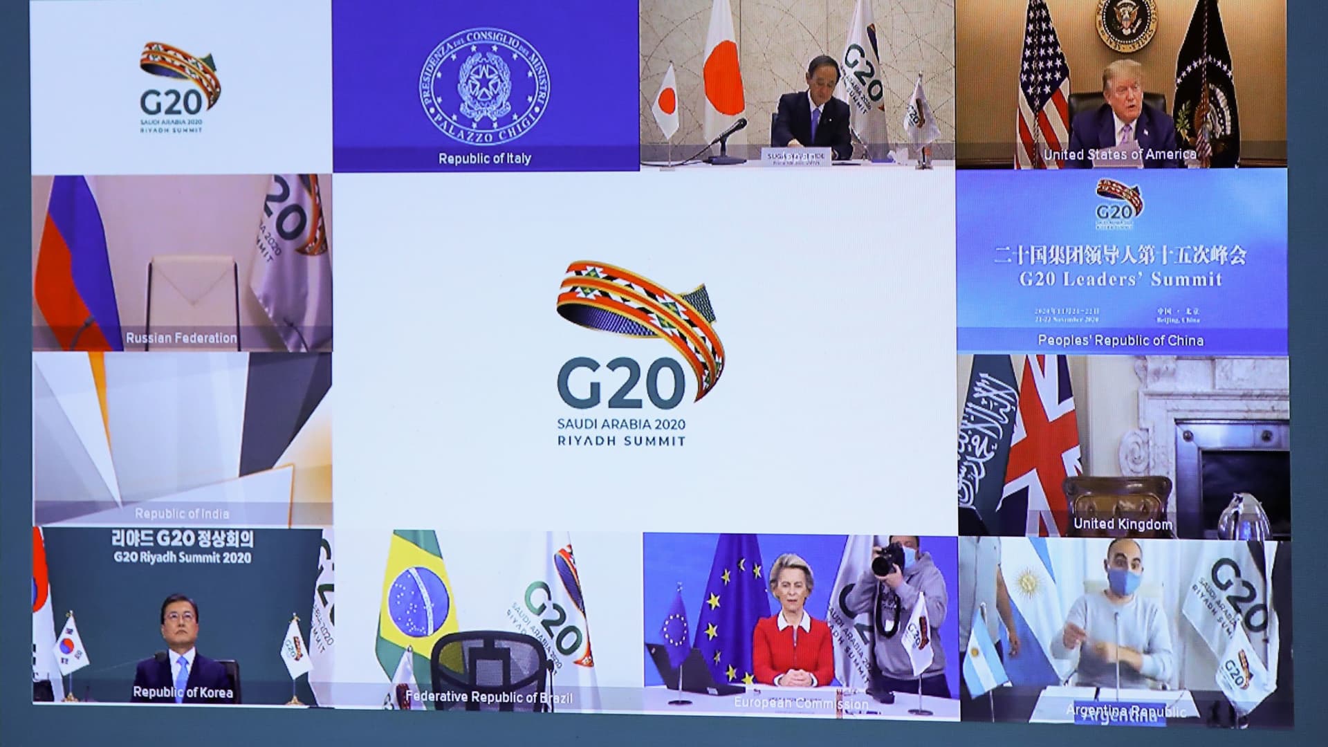 Japanese Prime Minister Yoshihide Suga (top L), US President Donald Trump (top R), South Korean President Moon Jae-in (down L), and European Commission President Ursula von der Leyen (down C) are seen on a screen before the start of a virtual G20 summit hosted by Saudi Arabia and held over video conference amid the Covid-19 (novel coronavirus) pandemic, in Brussels, on November 21, 2020.