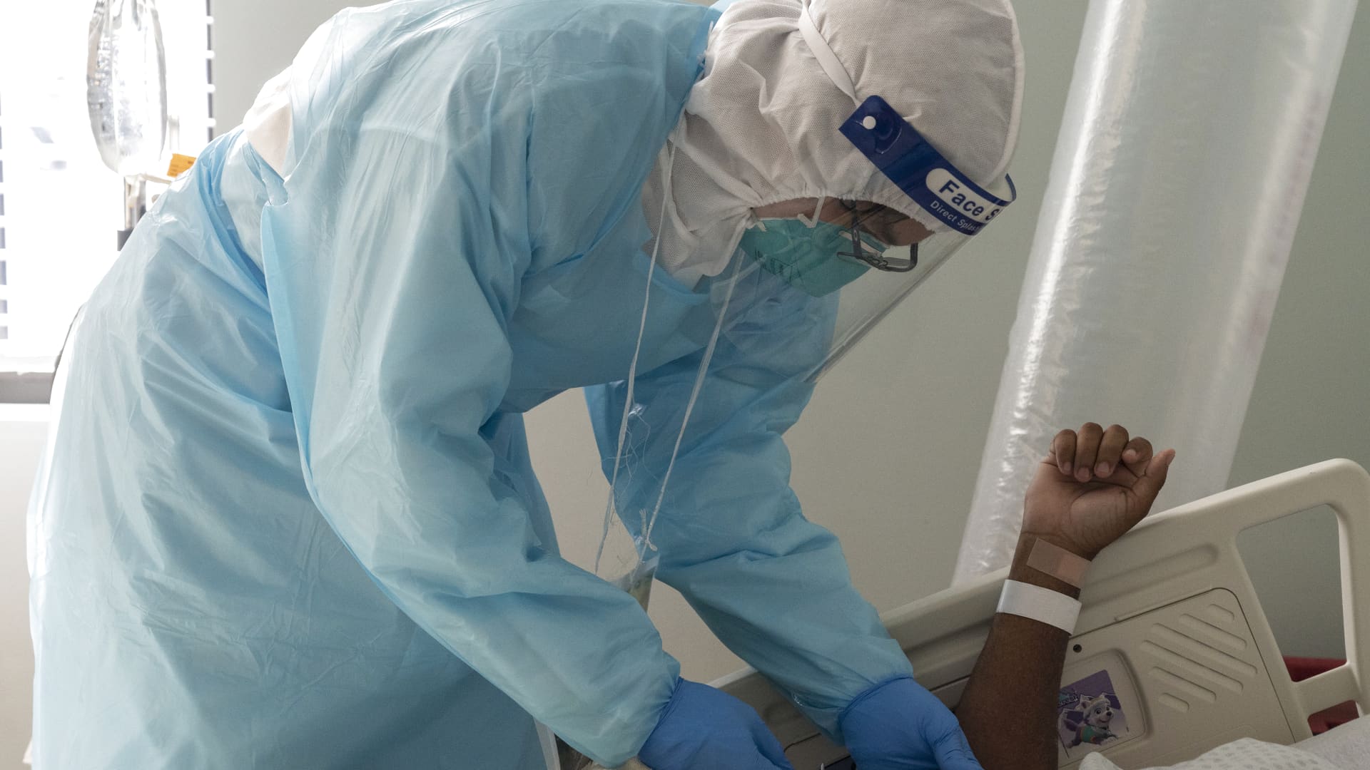 A medical staff member Cesar Barrera takes a blood sample from a patient suffering from the coronavirus disease (COVID-19) in the COVID-19 intensive care unit (ICU) at the United Memorial Medical Center on November 22, 2020 in Houston, Texas.