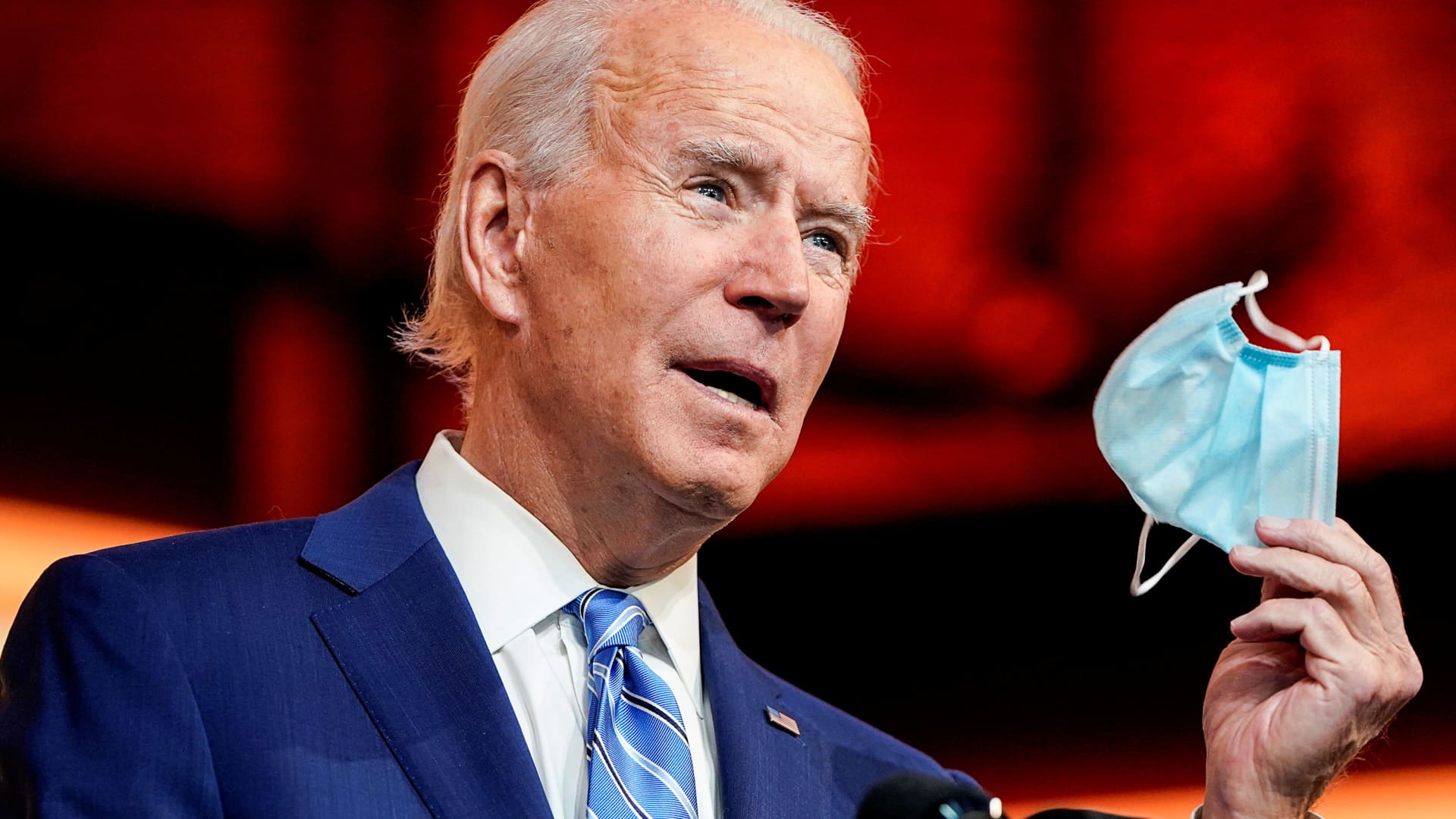 U.S. President-elect Joe Biden holds up a face mask while speaking about the coronavirus disease (COVID-19) as he delivers a pre-Thanksgiving address at his transition headquarters in Wilmington, Delaware, November 25, 2020.