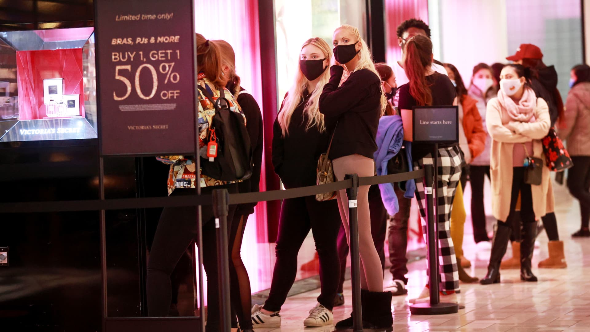 Shoppers stand in line as they wait for a Victoria's Secret store to open on Black Friday, at the Tysons Corner Center, in Tysons, Virginia, November 27, 2020.