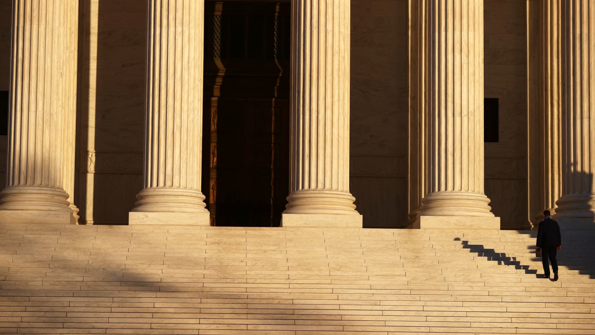 A person walks up the stairs of the U.S. Supreme Court building in Washington, U.S. November 10, 2020.