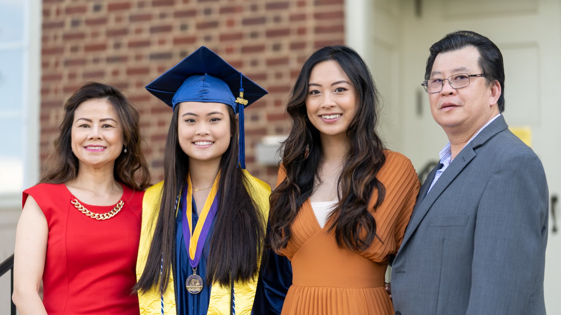 Kristina Truong with her parents, Christine Cao and Luat Truong, and her sister Jessica on Jessica's high school graduation day.
