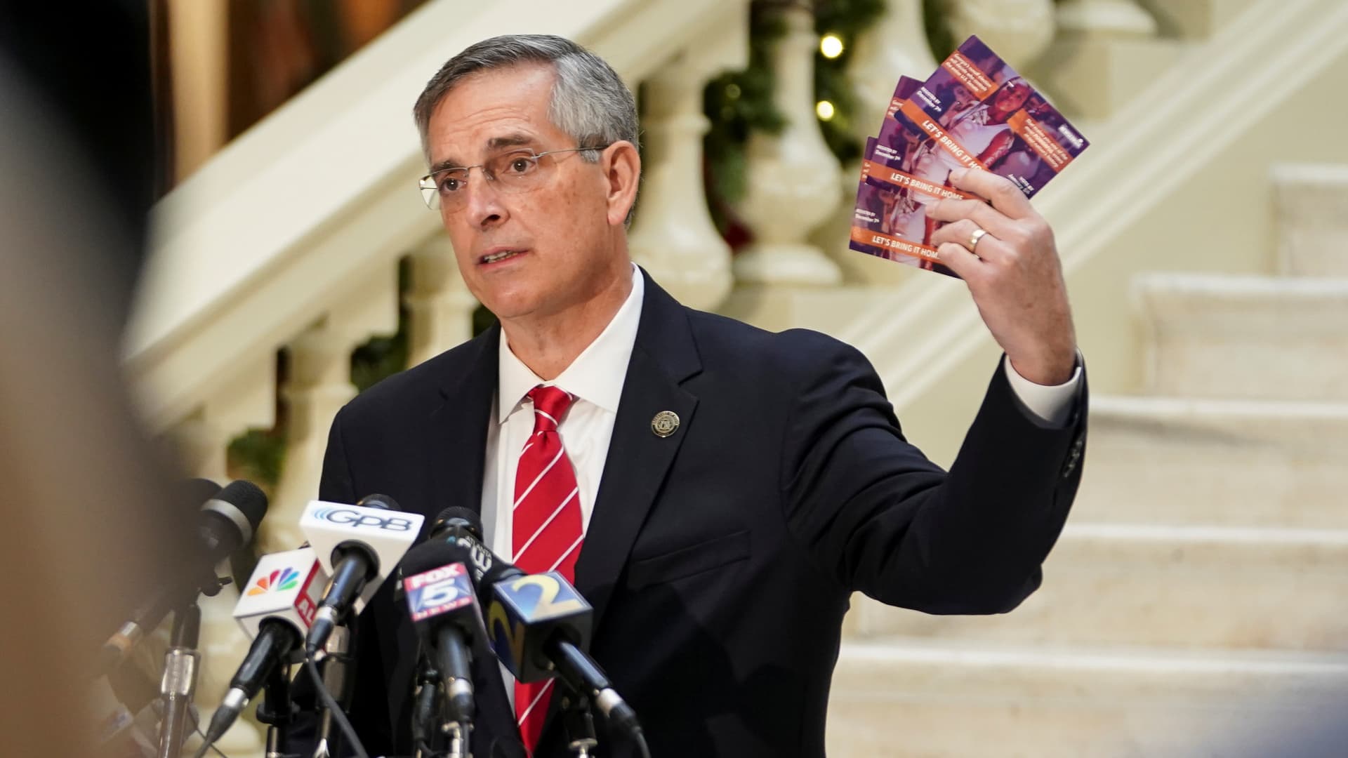 Georgia's Secretary of State Brad Raffensperger holds up election mail that he said arrived for his son, who is deceased, during a news conference on election results in Atlanta, Georgia, U.S., December 2, 2020.