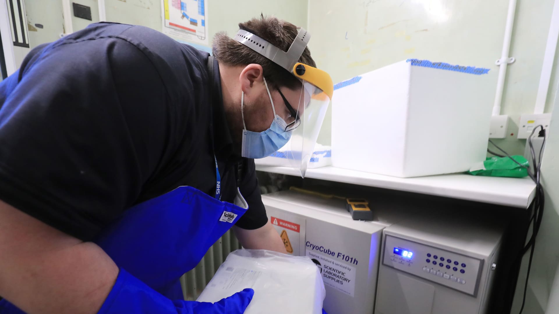 A pharmacy technician from Croydon Health Services takes delivery of the first batch of Covid-19 vaccinations at Croydon University Hospital in south London on December 5, 2020.