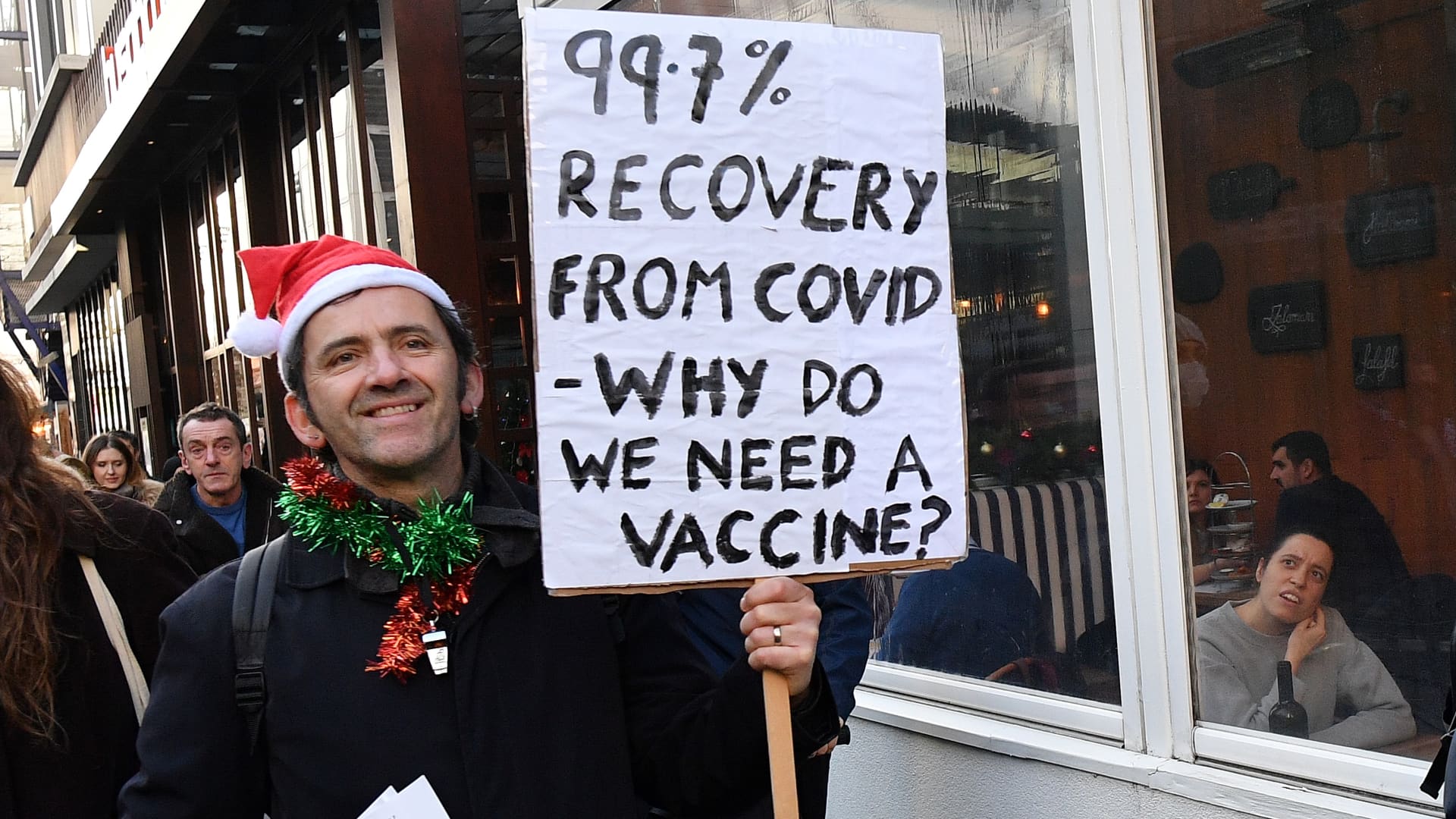 Demonstrator holding an anti-vaccine placard in east London on in central December 5, 2020.