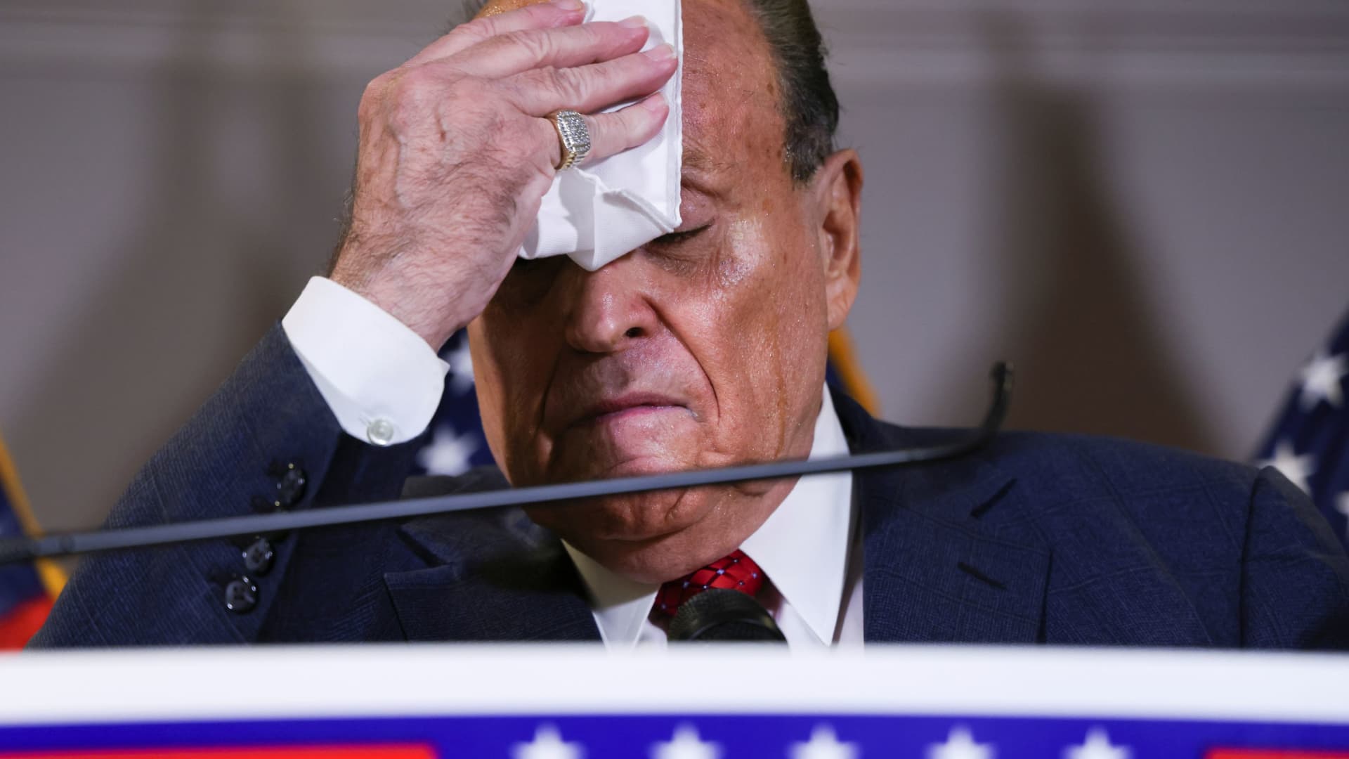 Former New York City Mayor Rudy Giuliani, personal attorney to U.S. President Donald Trump, wipes sweat from his face during a news conference about the 2020 U.S. presidential election results at Republican National Committee headquarters in Washington, U.S., November 19, 2020.