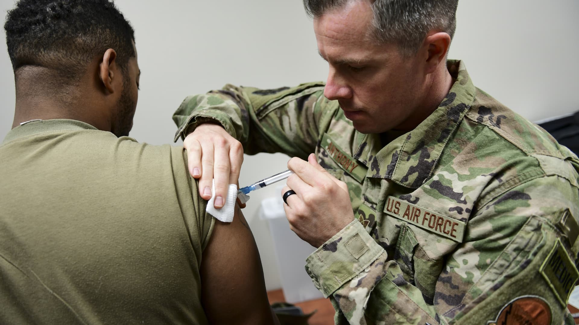 A medical technician administers a vaccination to a member of the U.S. Army Reserve's 336 Engineering Company Command and Control.