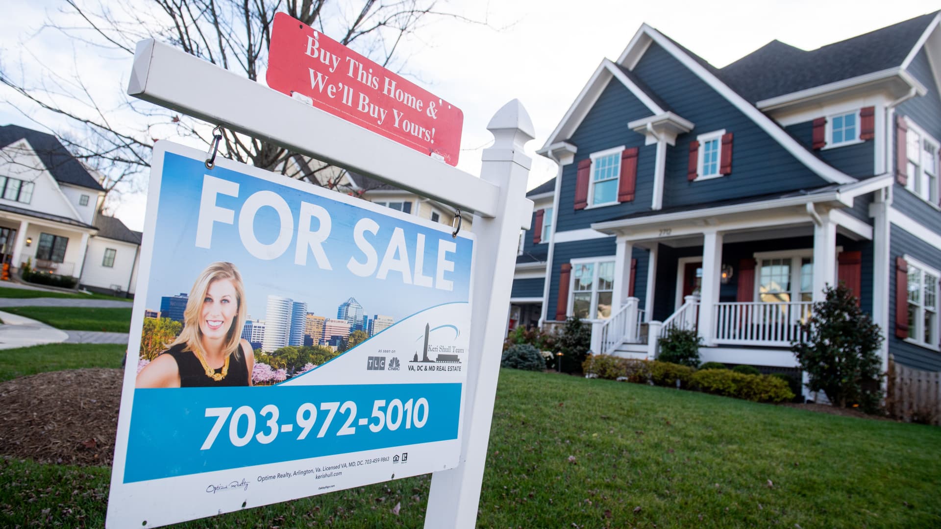 A house's real estate for sale sign is seen in front of a home in Arlington, Virginia, November 19, 2020.