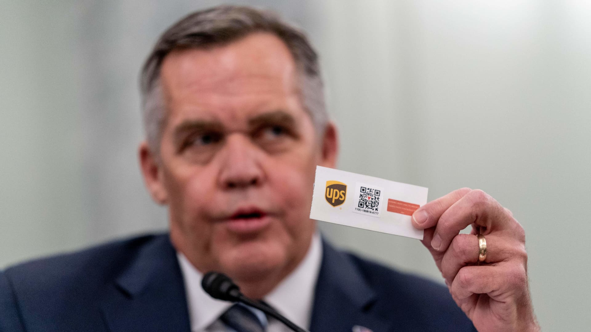 United Parcel Service President of Global Healthcare, Wesley Wheeler, holds up an example of one of UPSs tracking system as he speaks at a Senate Transportation subcommittee hybrid hearing on transporting a coronavirus vaccine on December 10, 2020, in Washington, DC.