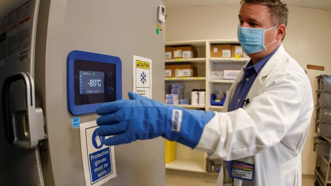 Pharmacy supervisor Kevin Weissman uses a thick glove as he opens the door of a special freezer that will hold the Pfizer vaccine at LAC USC Medical Center during the outbreak of the coronavirus disease (COVID-19) in Los Angeles, California, December 10, 
