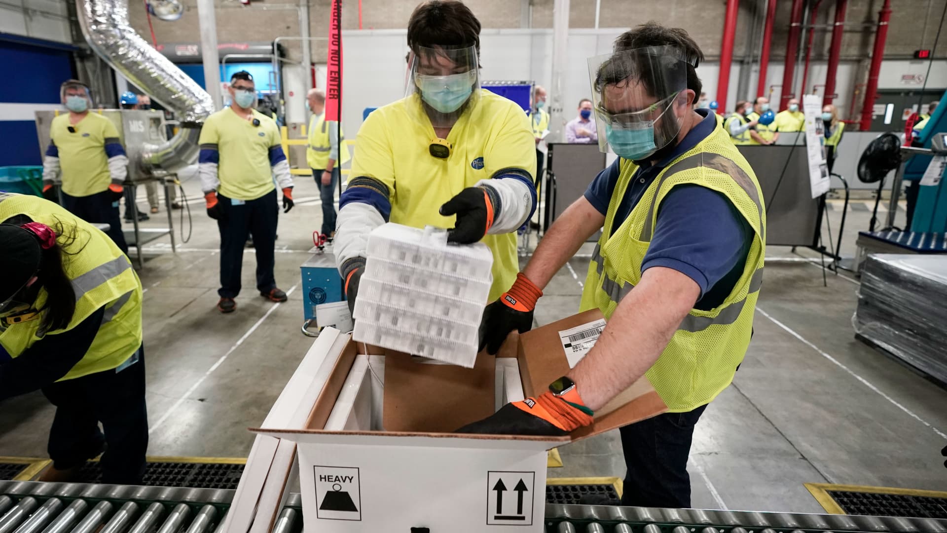 Boxes containing the Pfizer-BioNTech Covid vaccine are prepared to be shipped at the Pfizer Global Supply Kalamazoo manufacturing plant on December 13, 2020 in Portage, Michigan.