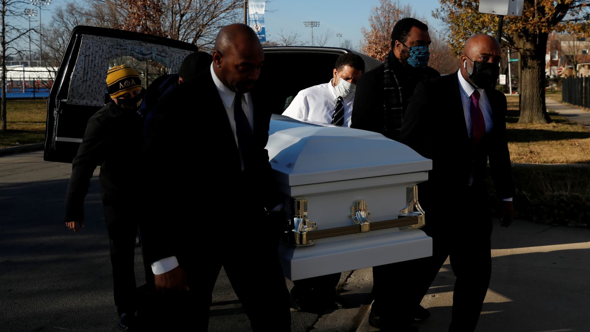 Sammie Michael Dent, Jr., the grandson of Florence Bolton, a coronavirus disease (COVID-19) positive patient that died on November 2nd at Roseland Community Hospital, carries her casket into Zion Evangelical Lutheran Church on the South Side of Chicago, Illinois, U.S., December 9, 2020.