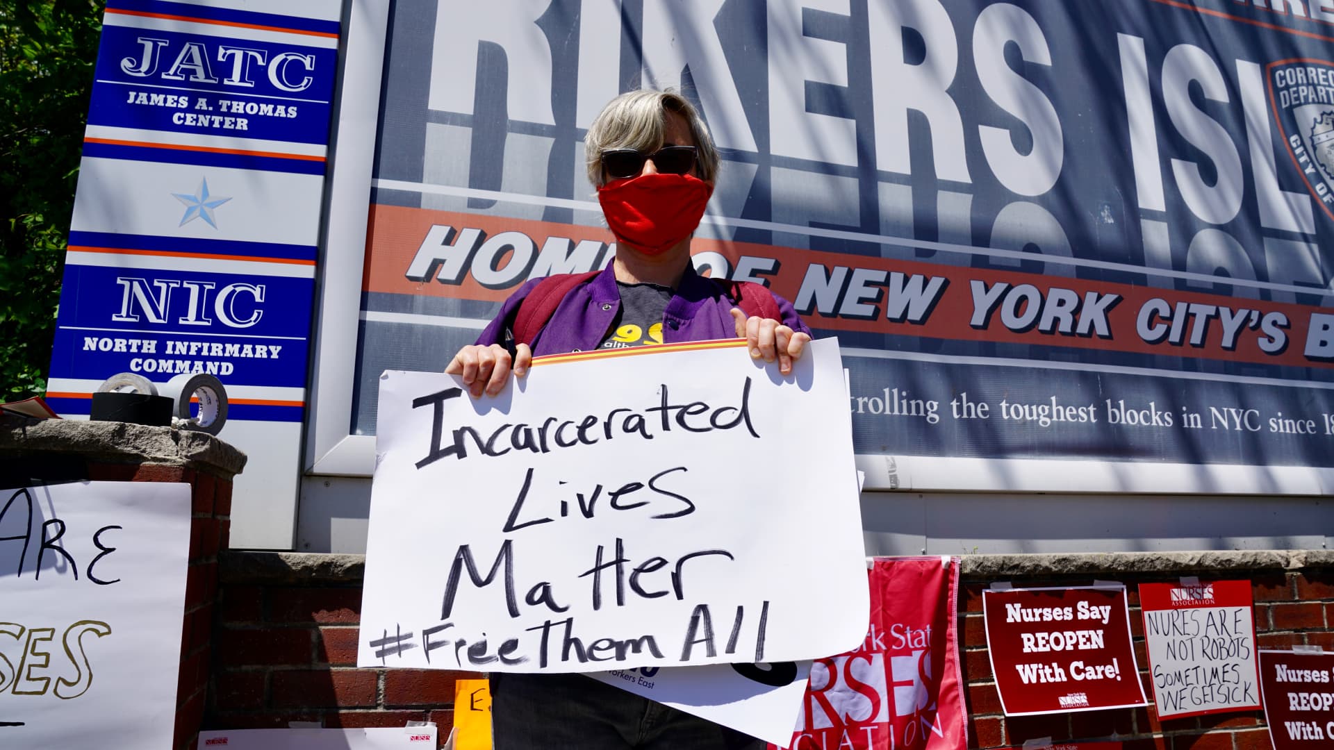 A nurse holds a sign during a nurses protest at Rikers Island Prison over conditions and coronavirus threat on May 7, 2020 in New York City.