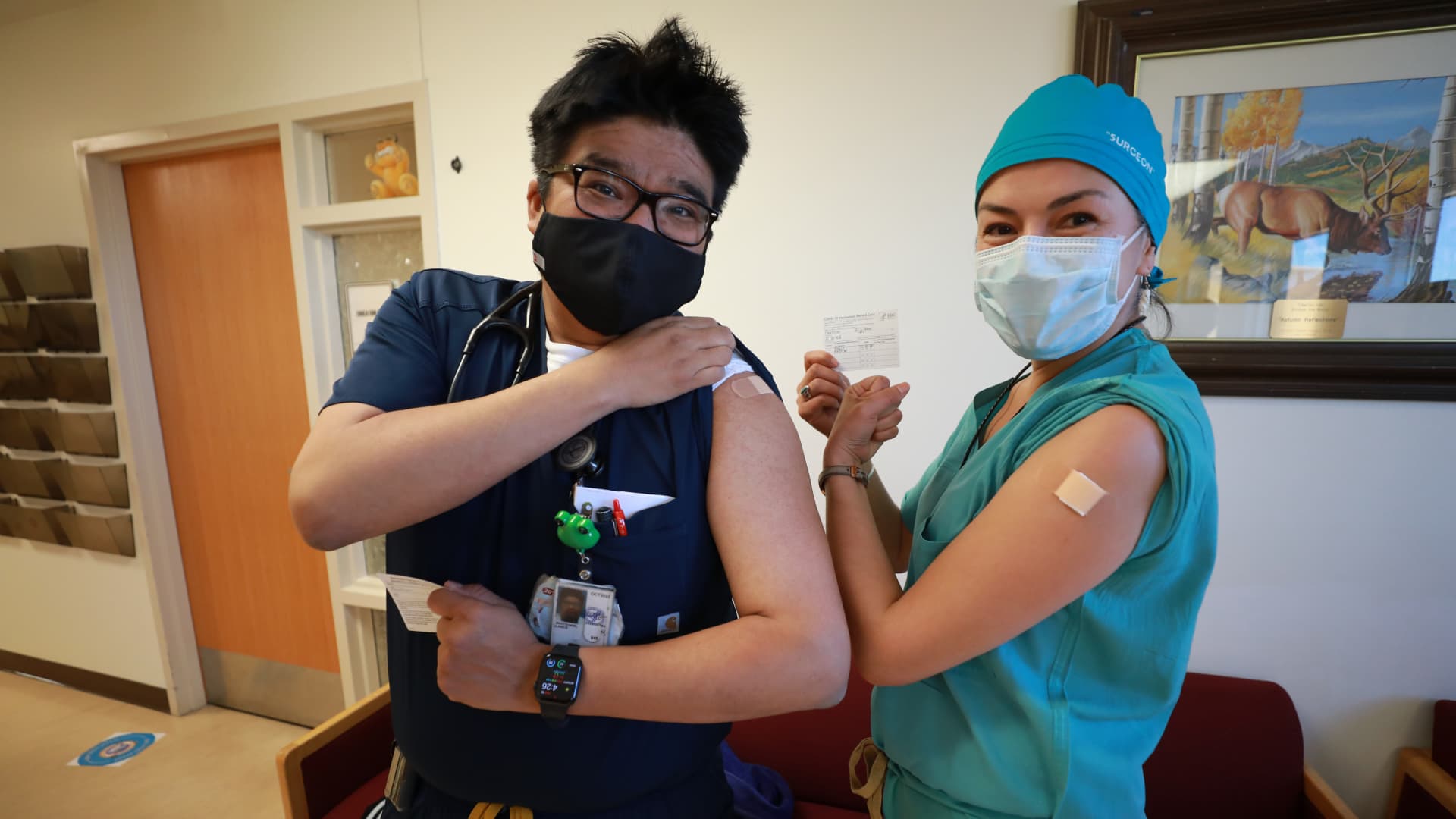 Lance Whitehair (L), a Navajo doctor, and Bijiibaa' Kristin Garrison, a Navajo surgeon, pose for photos after receiving their COVID-19 vaccines at Northern Navajo Medical Center on December 15, 2020 in Shiprock, New Mexico.