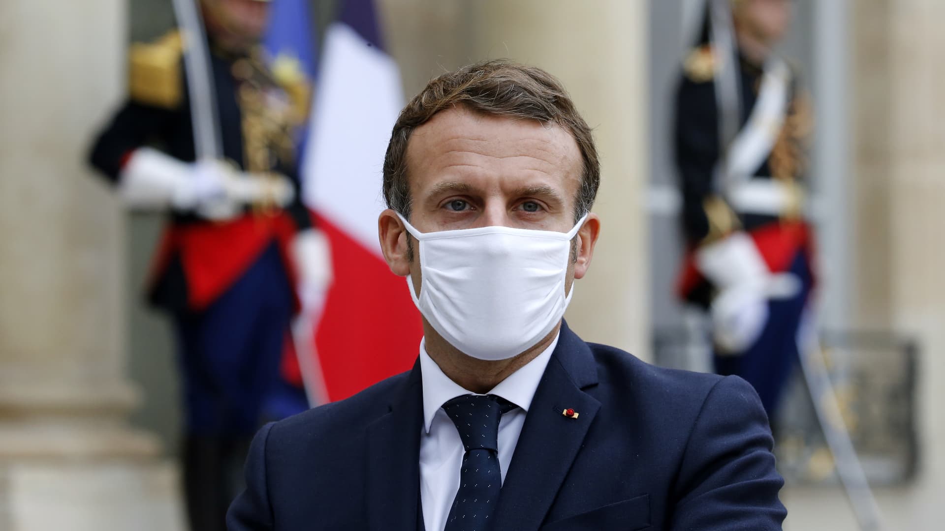 French President Emmanuel Macron wearing a protective face mask looks on as he makes a statement next to Estonian Prime Minister Juri Ratas following their meeting at the Elysee Palace on October 28, 2020 in Paris, France.