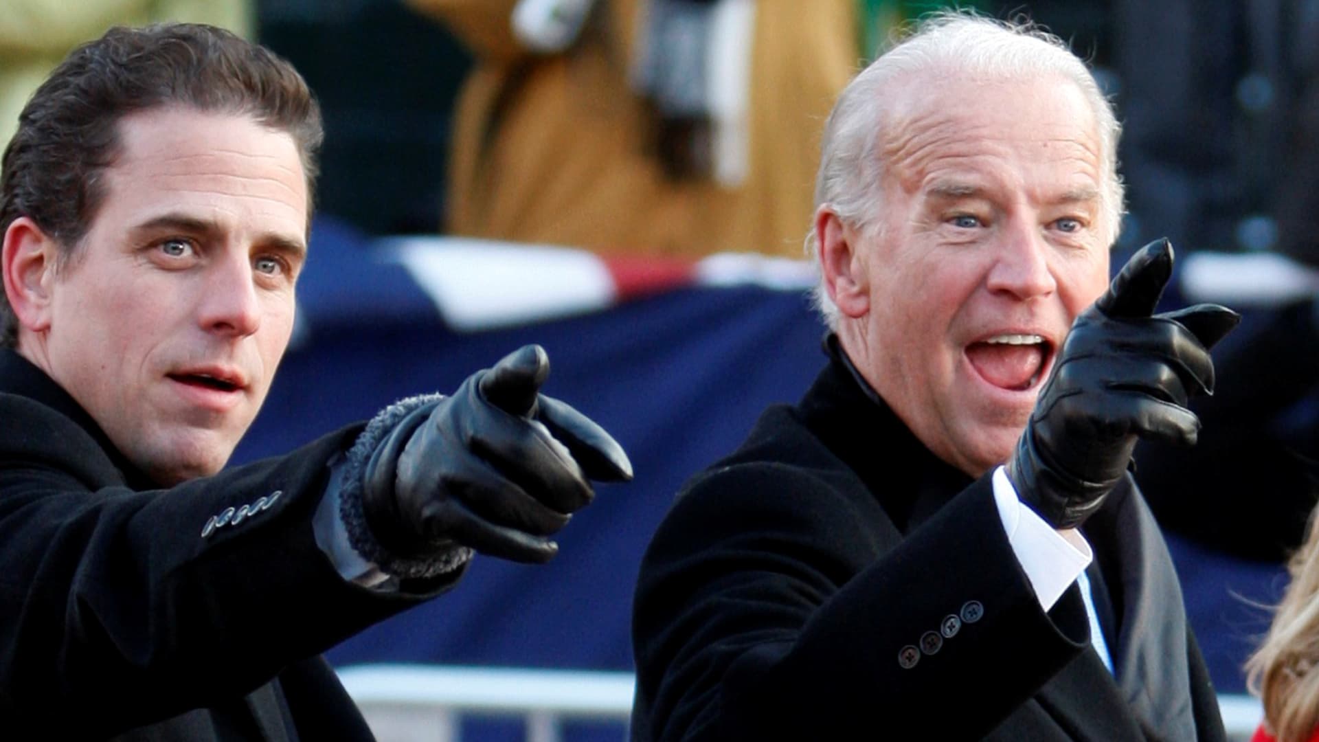 U.S. Vice President Joe Biden (R) points to some faces in the crowd with his son Hunter as they walk down Pennsylvania Avenue following the inauguration ceremony of President Barack Obama in Washington, January 20, 2009.