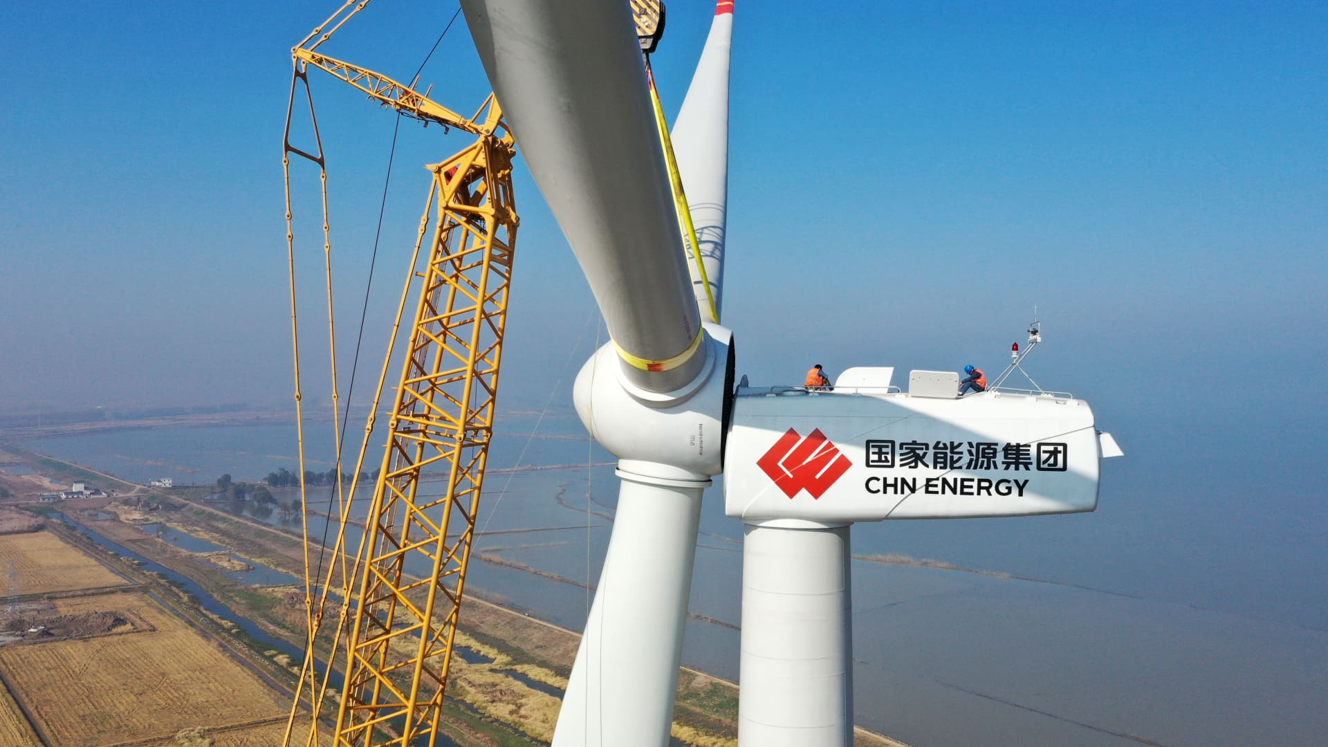 Workers install wind turbines at a wind farm on November 16, 2020 in Anqing, Anhui Province of China.