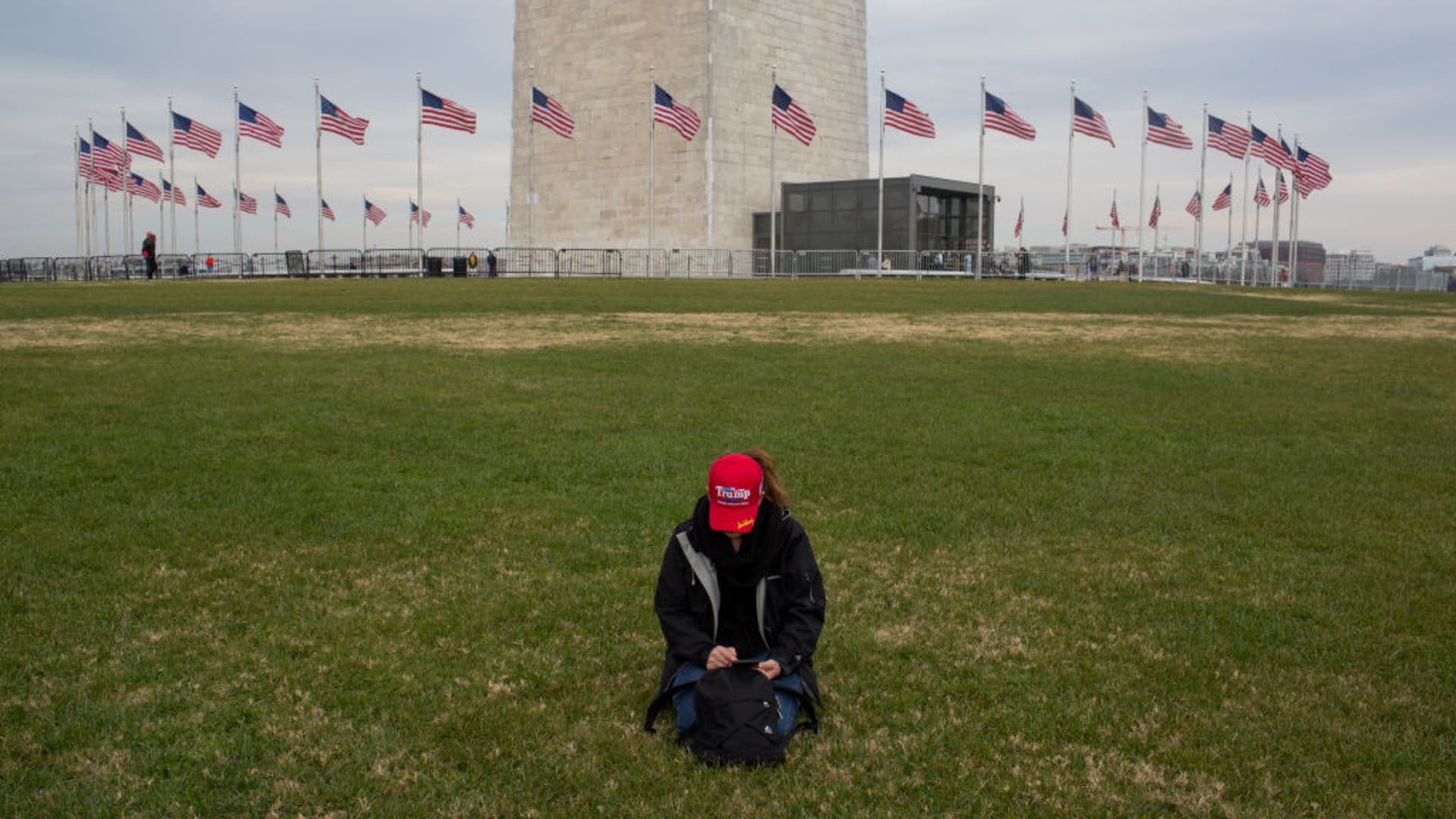 A lone Trump supporter rests on the National Mall in front of the Washington Monument at a sparsely attended rally demonstrating against the election results on December 12, 2020 in Washington, D.C.
