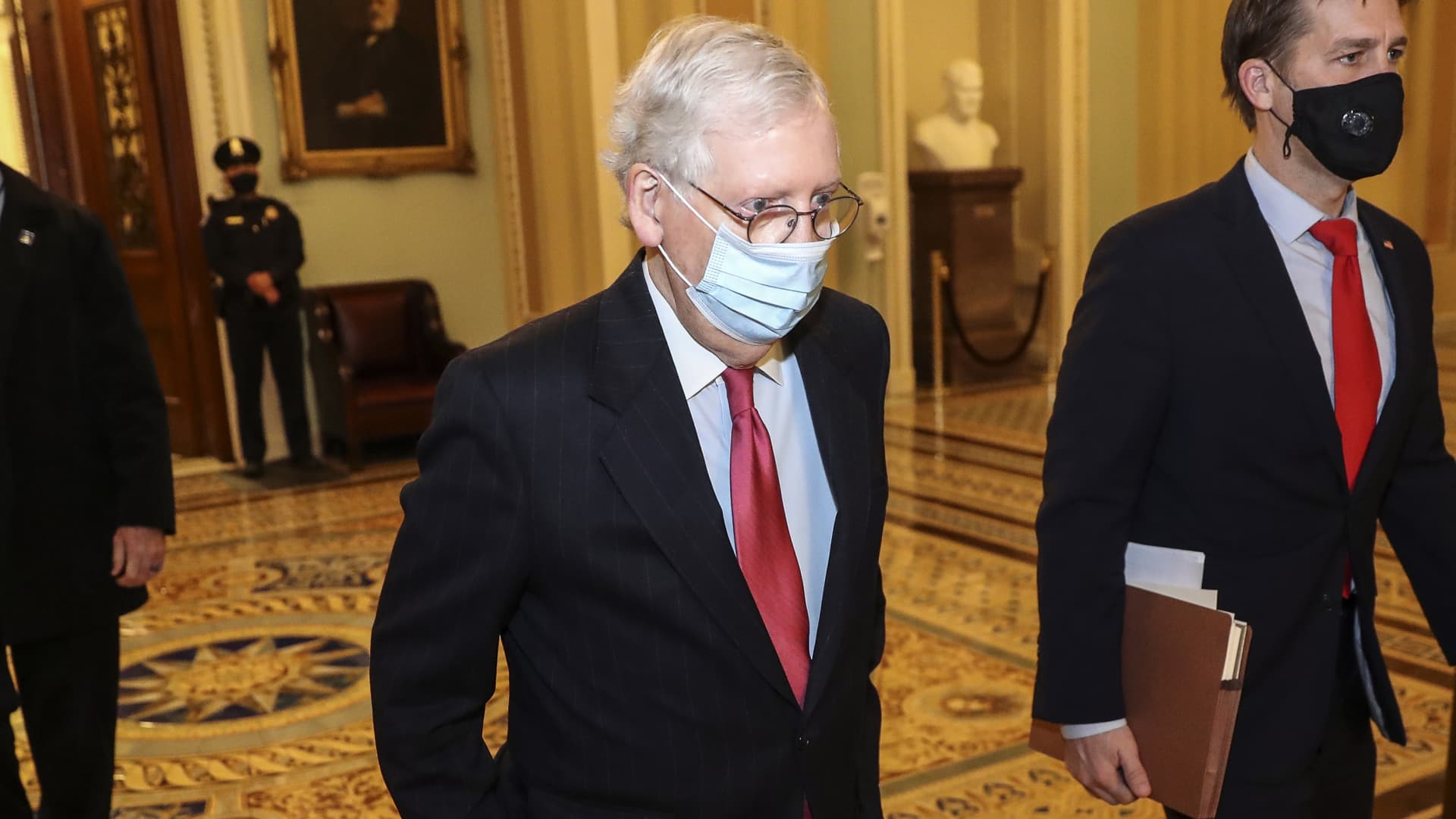 Senate Majority Leader Mitch McConnell, a Republican from Kentucky, wears a protective mask while walking to his office at the U.S. Capitol in Washington, D.C., U.S., on Monday, Dec. 21, 2020.