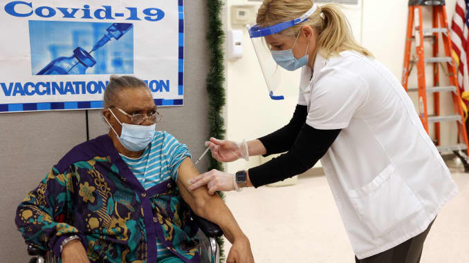 Ina Siler, a patient at Crown Heights Center for Nursing and Rehabilitation, a nursing home facility, receives the Pfizer-BioNTech coronavirus disease (COVID-19) vaccine from Walgreens pharmacist Annette Marshall, in Brooklyn, New York, December 22, 2020.