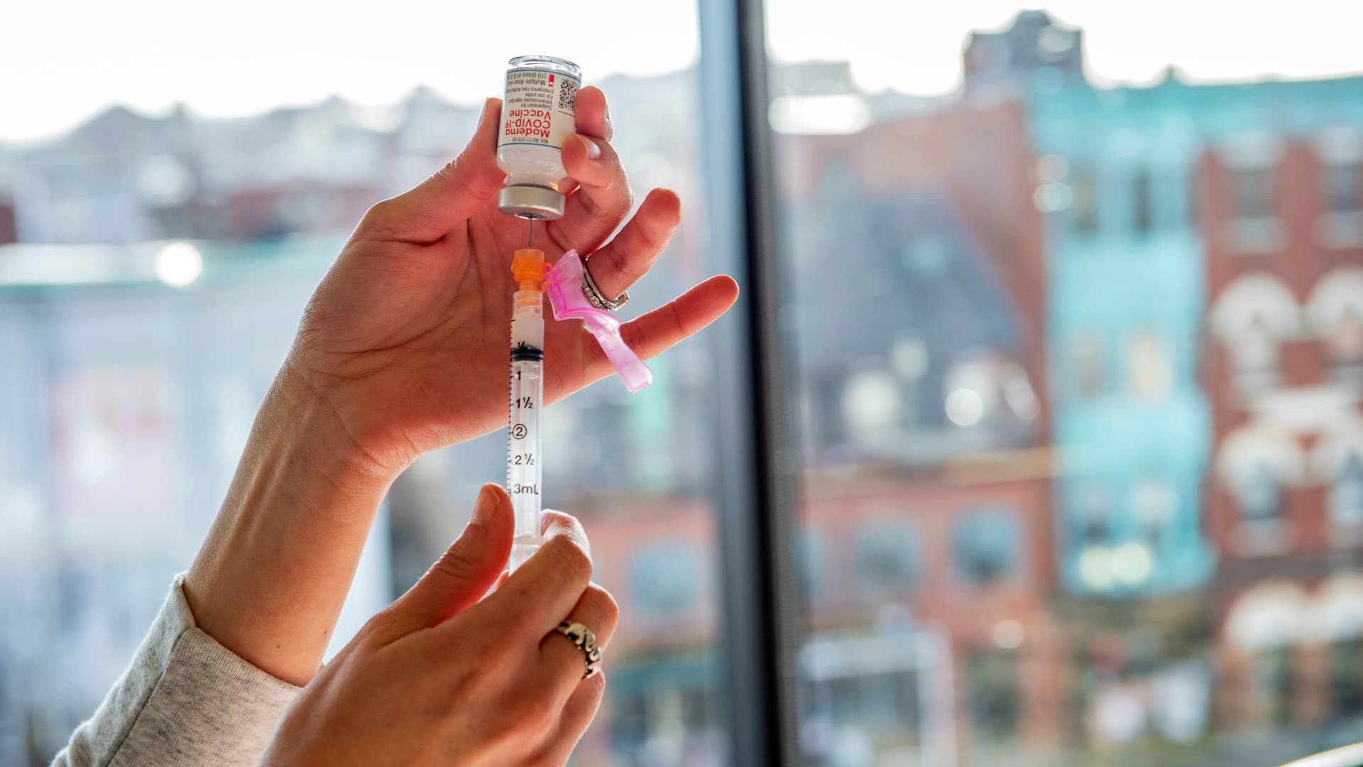 A nurse prepares a syringe with the Moderna vaccine at the East Boston Neighborhood Health Center (EBNHC) in Boston, Massachusetts on December 24, 2020.