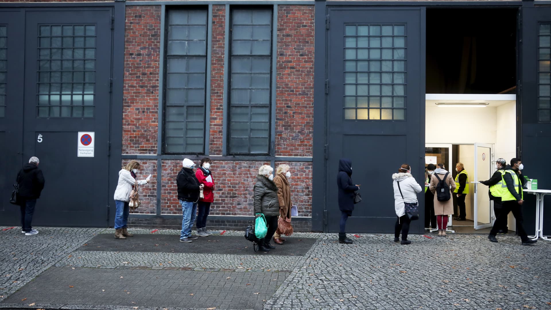 Visitors queue outside a Covid-19 vaccination site at Berlin Arena in Berlin, Germany.