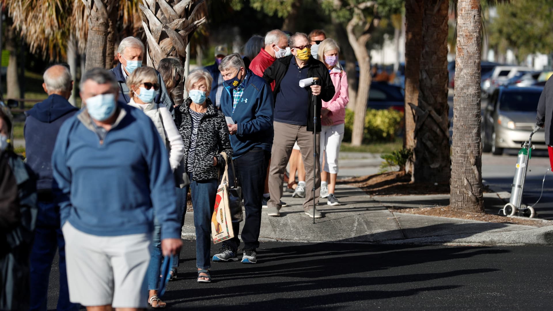 Seniors, who are 65 and over, wait in line at the Department of Health Sarasota COVID-19 Vaccination Clinic in Sarasota, Florida, January 4, 2021.