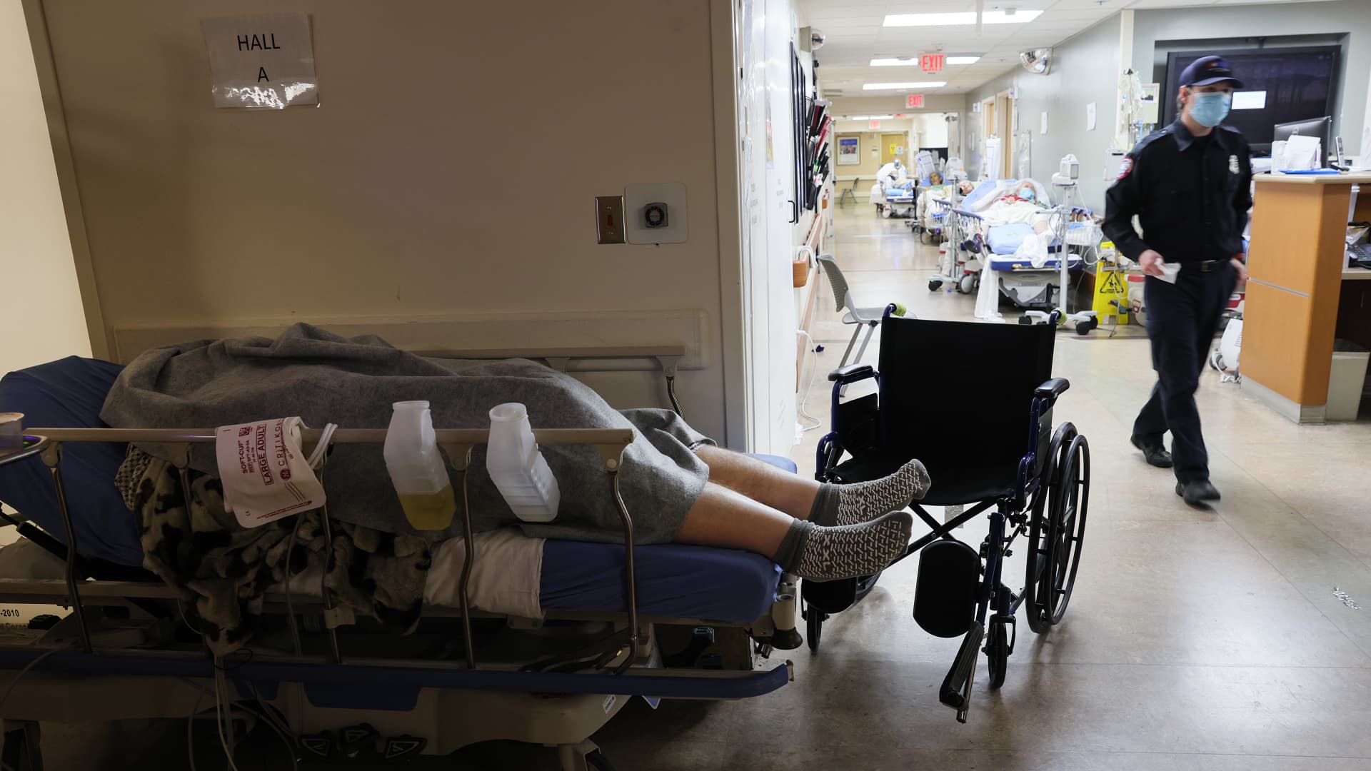 A patient lies on a stretcher in a hallway near other patients in the overloaded Emergency Room at Providence St. Mary Medical Center amid a surge in COVID-19 patients in Southern California on January 5, 2021 in Apple Valley, California.