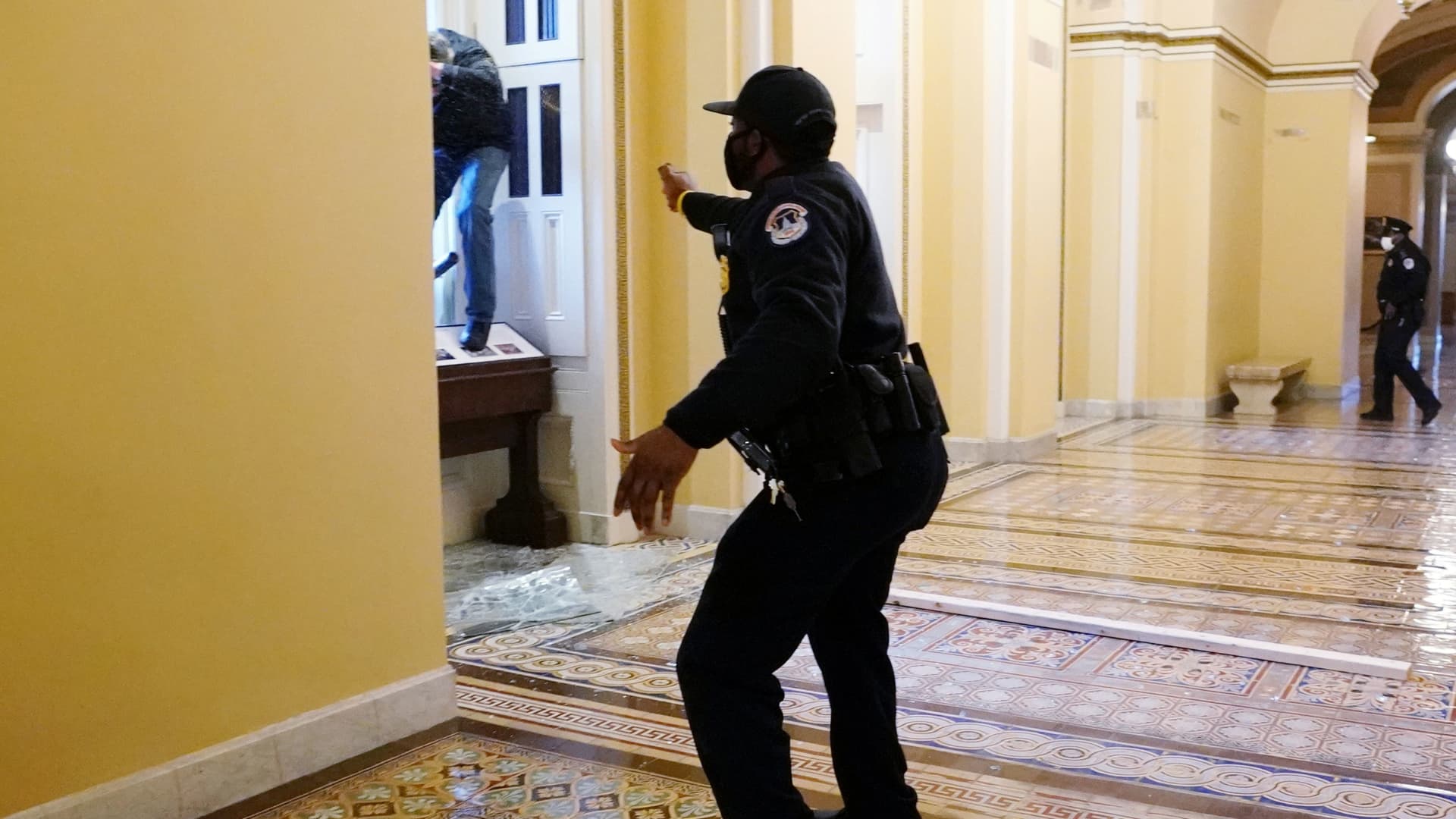 A U.S. Capitol police officer shoots pepper spray at a protestor attempting to enter the Capitol building during a joint session of Congress to certify the 2020 election results on Capitol Hill in Washington, January 6, 2021.
