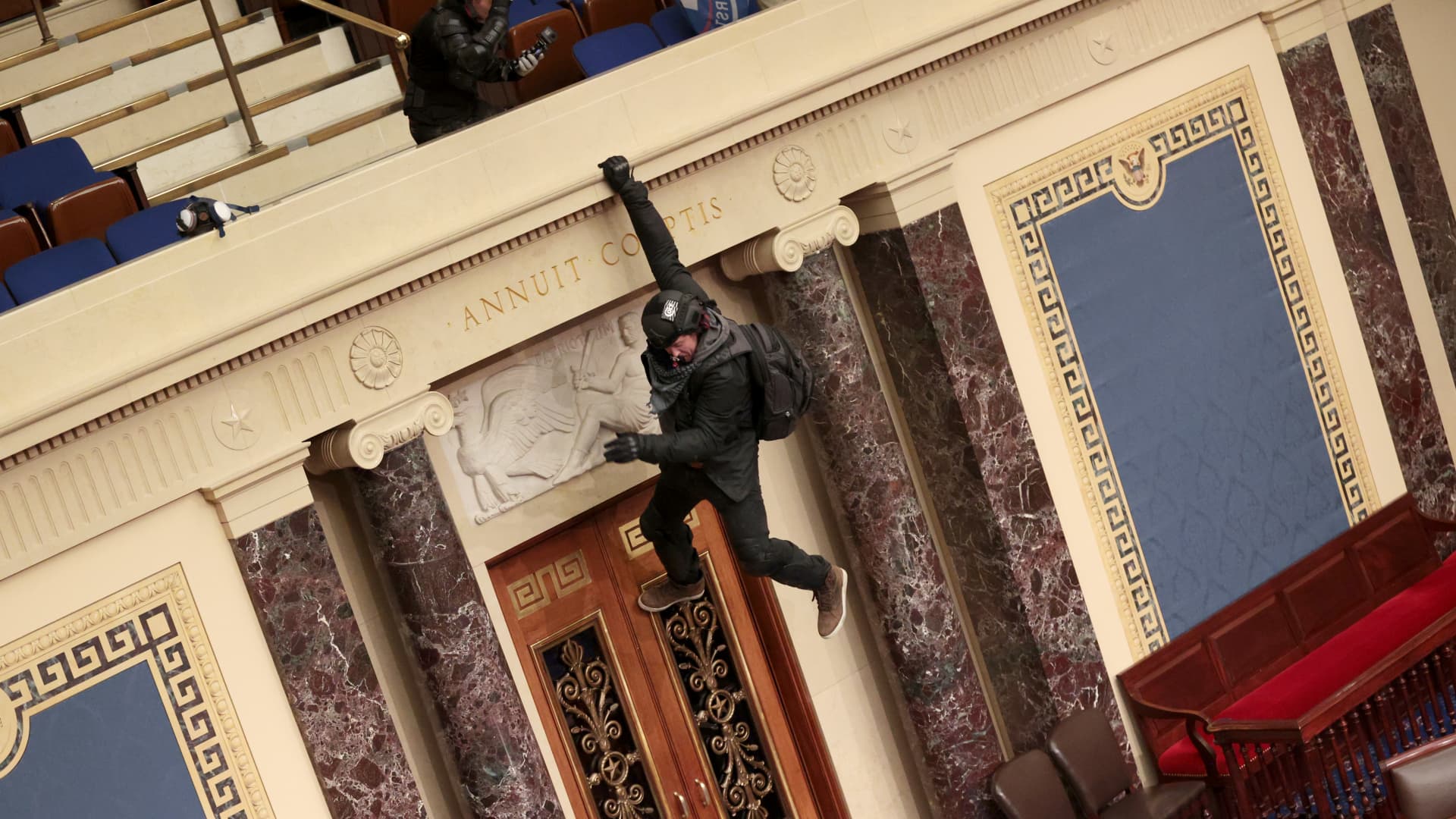 A protester dangled from the balcony in the Senate Chamber on January 6, 2021, in Washington.