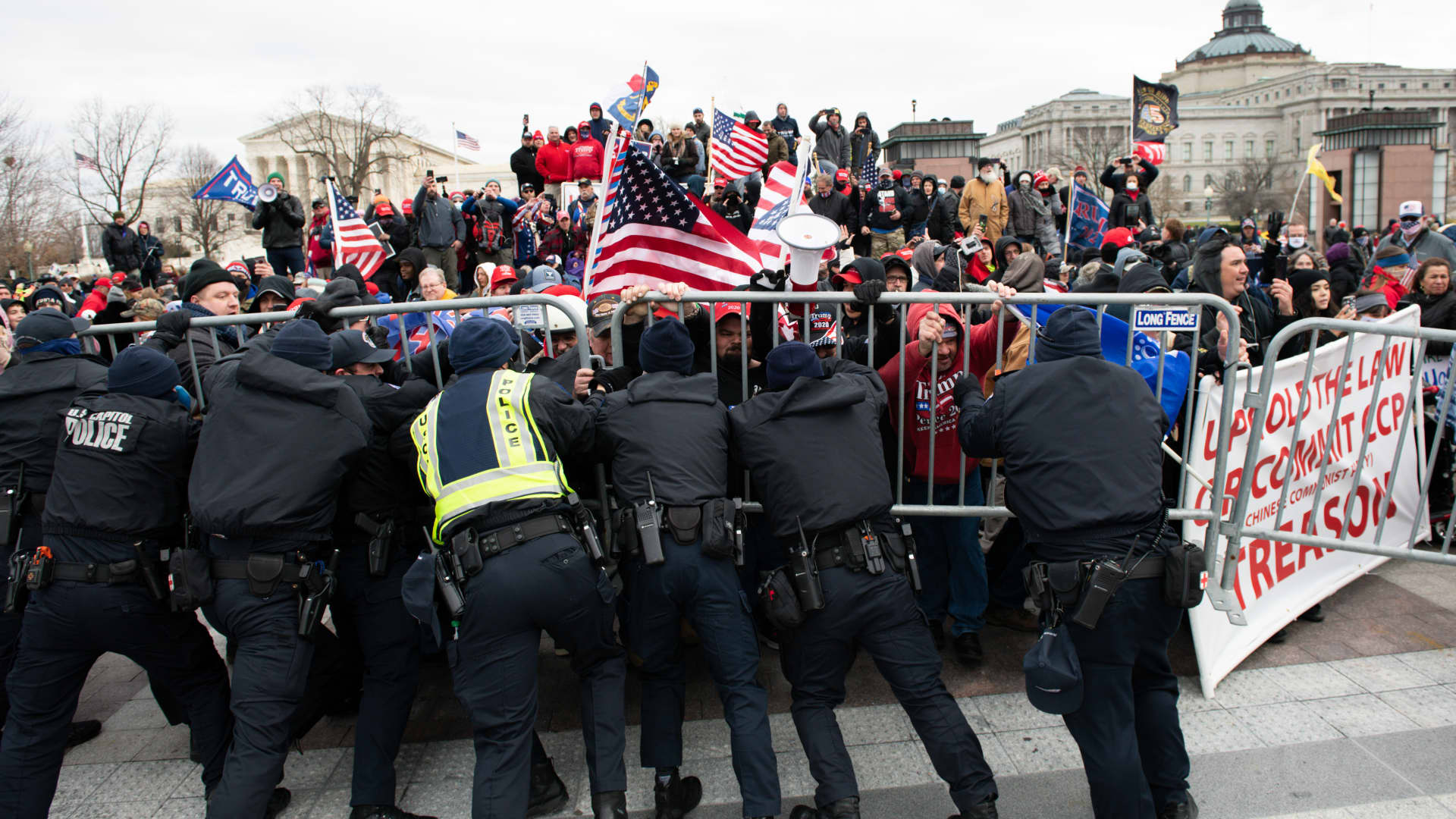 U.S. Capitol Police scuffle with demonstrators after they broke through security fencing outside of the U.S. Capitol building in Washington, D.C., U.S., on Wednesday, Jan. 6, 2021.