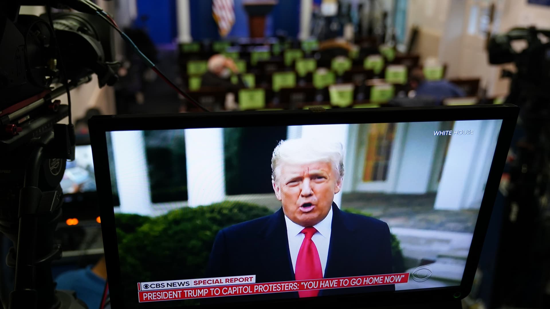 US President Donald Trump is seen on TV from a video message released on Twitter, seen in an empty Brady Briefing Room at the White House in Washington, DC on January 6, 2020.