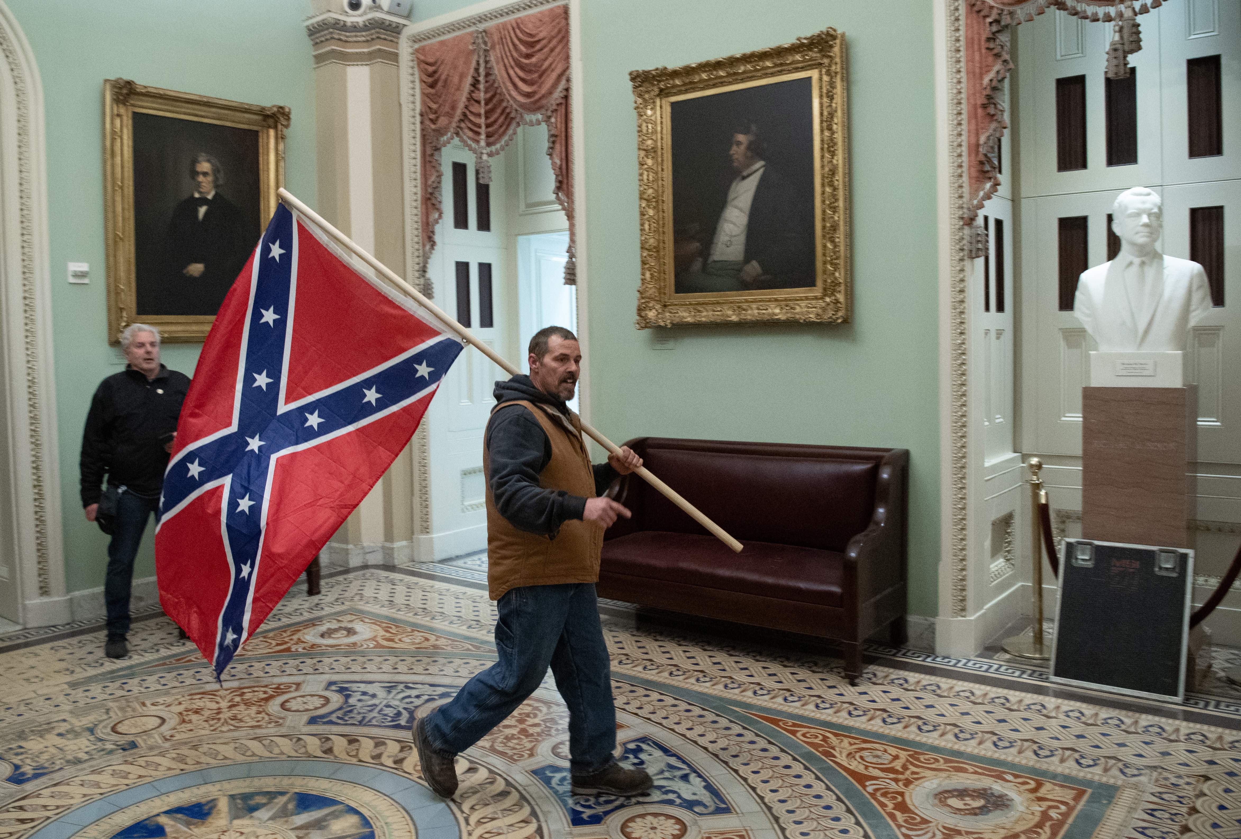 Man carrying Confederate flag to Capitol during riot