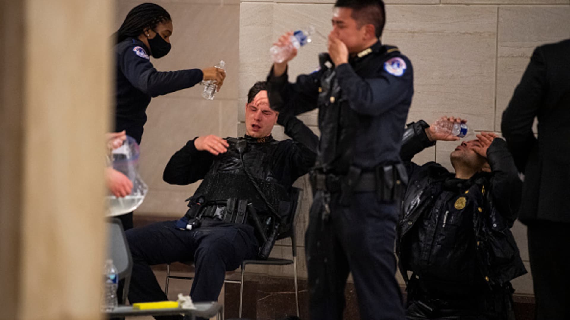 Capitol Police officers receive medical treatment after clashes with protesters attempting to disrupt the joint session of Congress to certify the Electoral College vote on Wednesday, January 6, 2021.