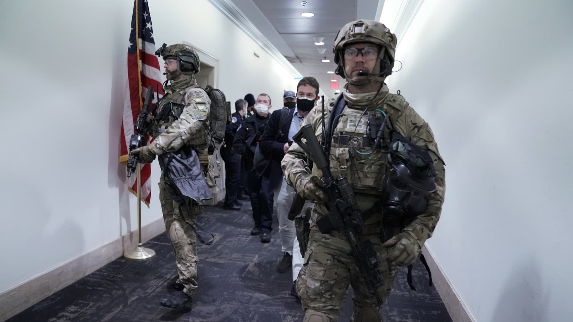 Members of the Federal Bureau of Investigation (FBI) swat team patrol the Longworth House Office building after a joint session of Congress to count the votes of the 2020 presidential election took place in Washington, D.C., U.S., on Wednesday, Jan. 6, 2021.